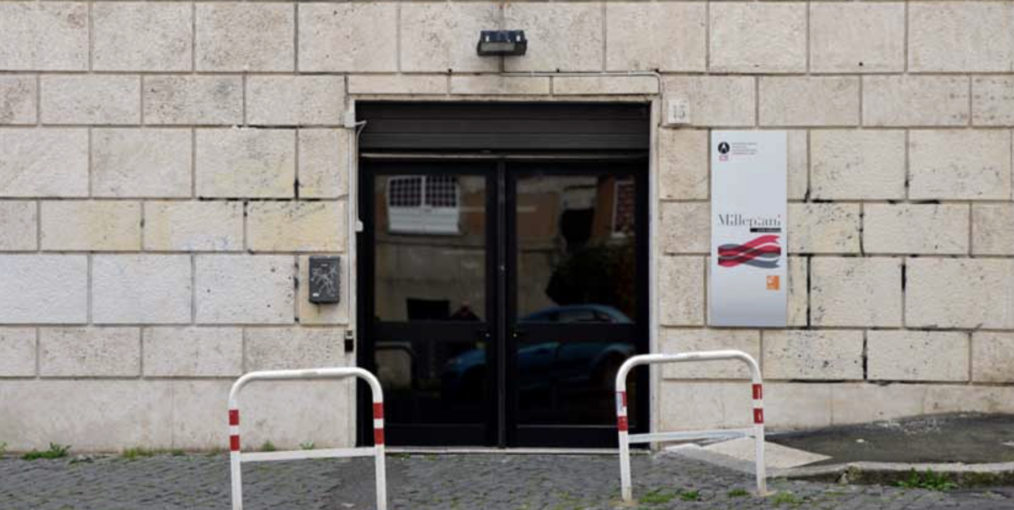 Millepiani Gallery entrance with a glass door, with Millepiani's sign on the right side.