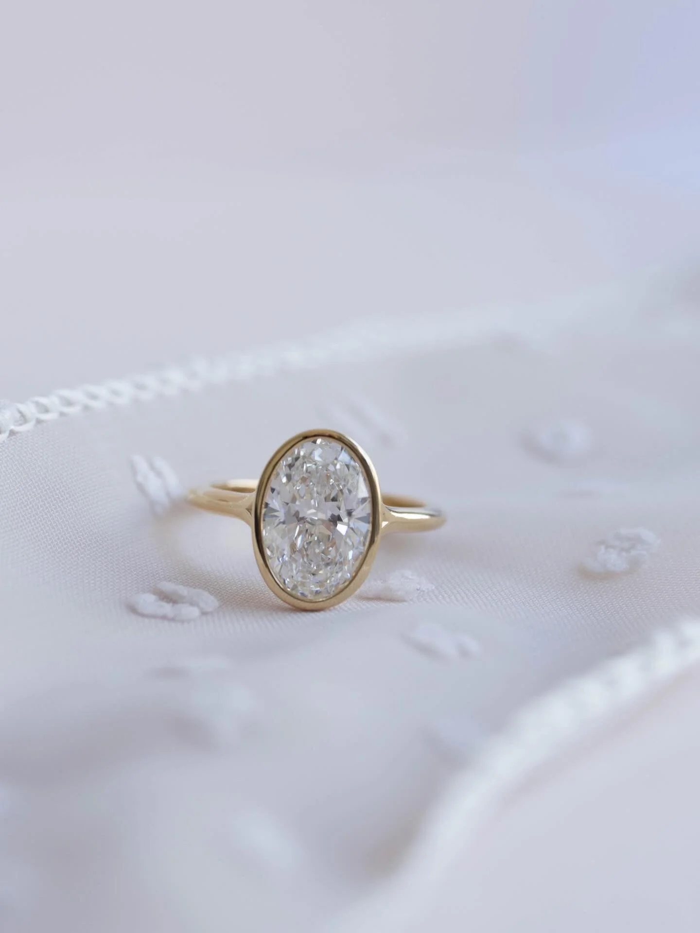 Beautiful &amp; bezeled baby ✨

2.5 🥕 &bull; 14k yellow gold bezel &bull; mini split shank 

[oval bezel diamond ring , bezel engagement ring, bezel diamond ring, oval diamond ring]