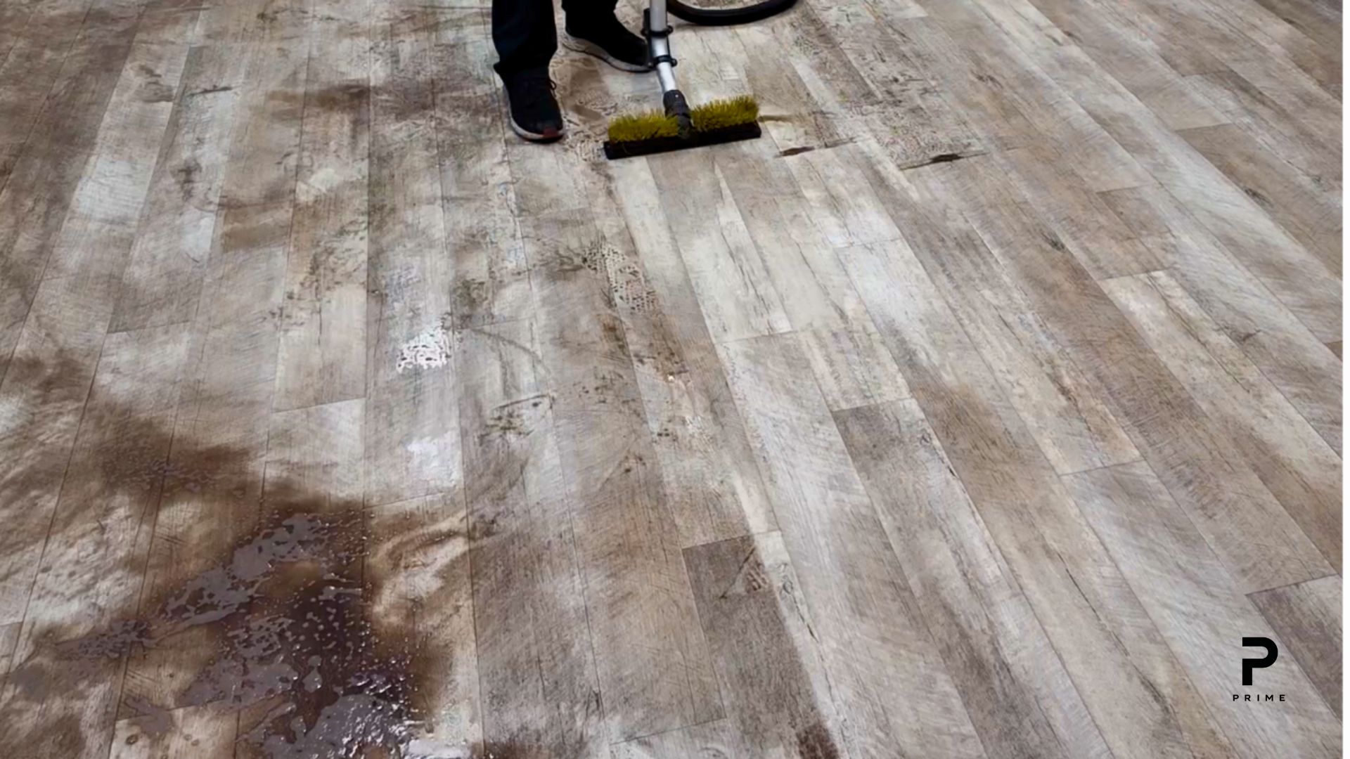 Before commercial floor stripping and waxing showing worn finish and heavy buildup