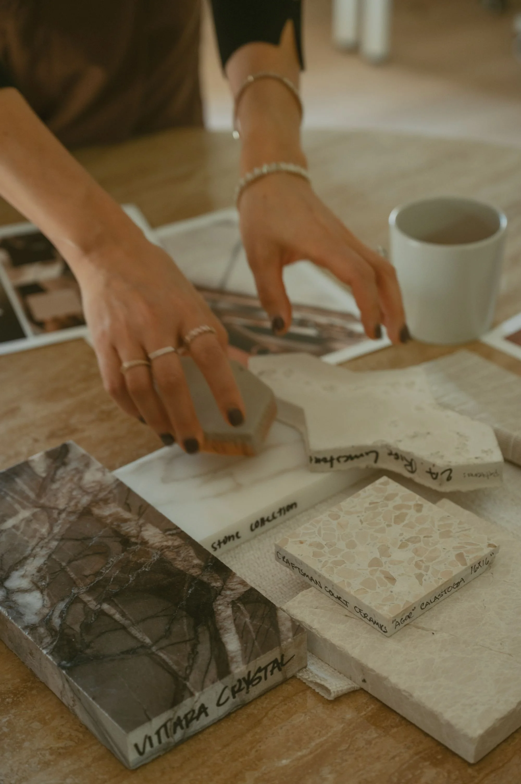 Interior designer selecting tile and material samples during a hospitality design project
