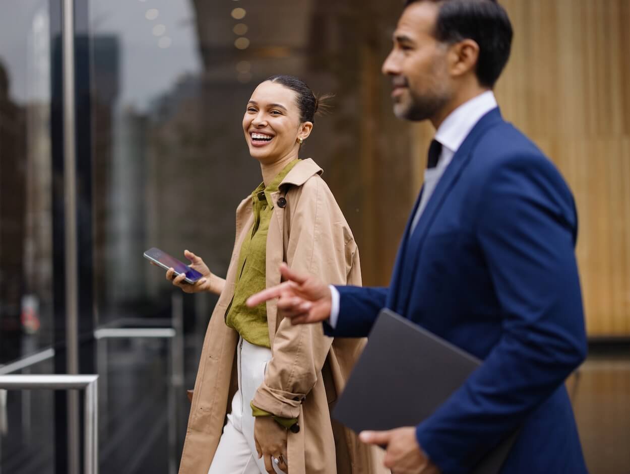 Real estate professionals walking and talking in New York City.