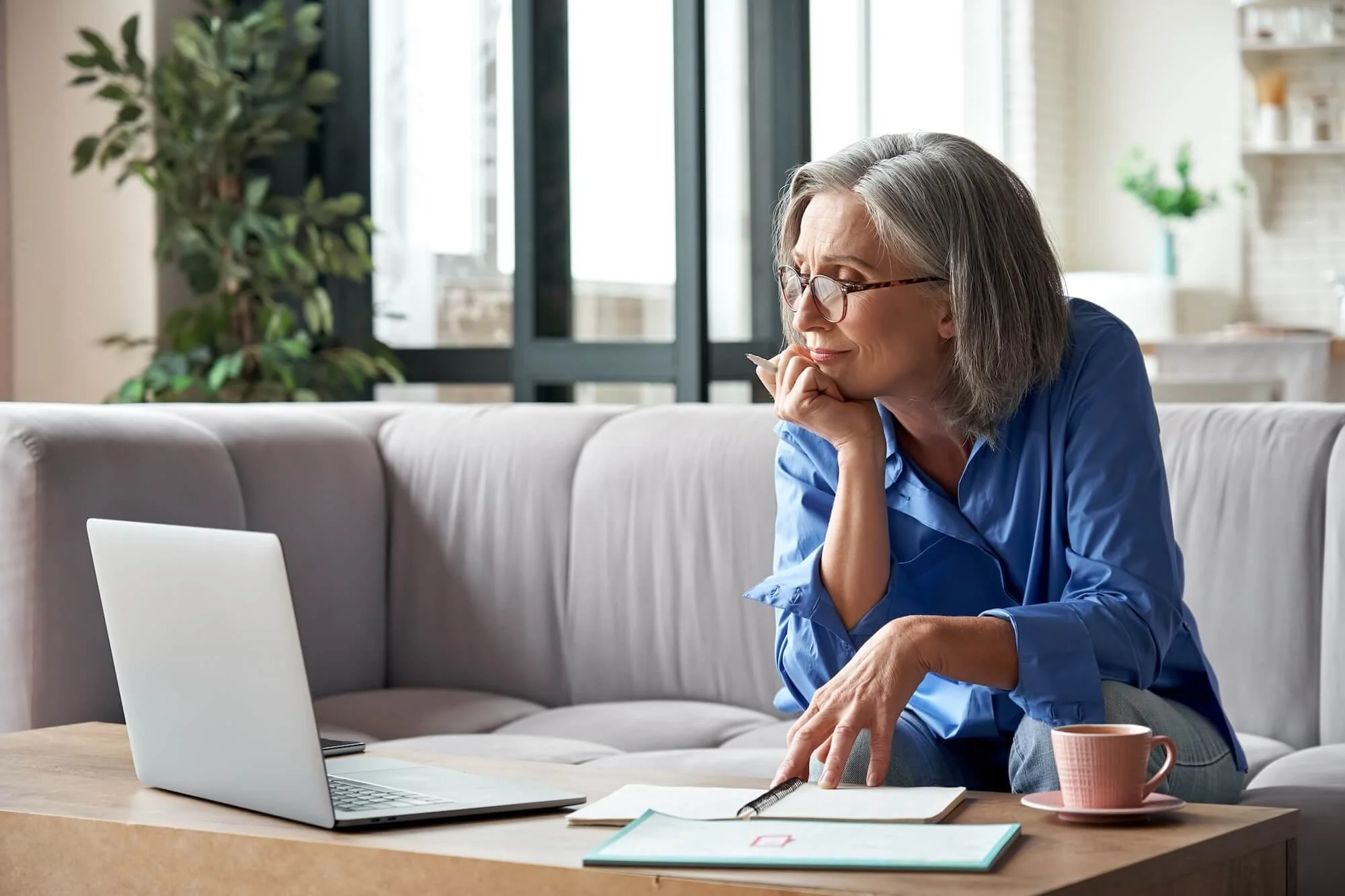 Female real estate agent watching training videos on her laptop.