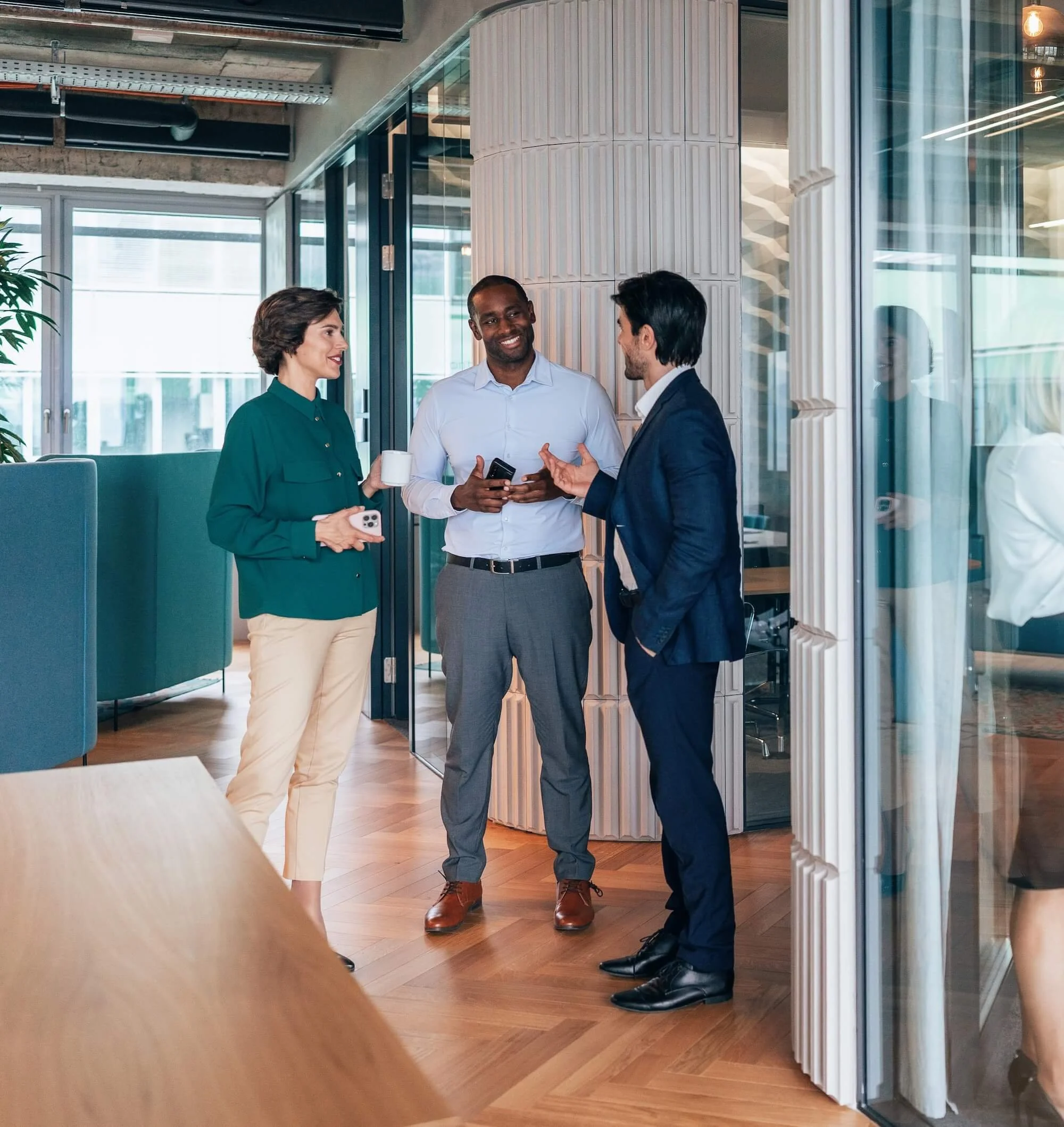 Real estate agents talking the the hallway of their office.
