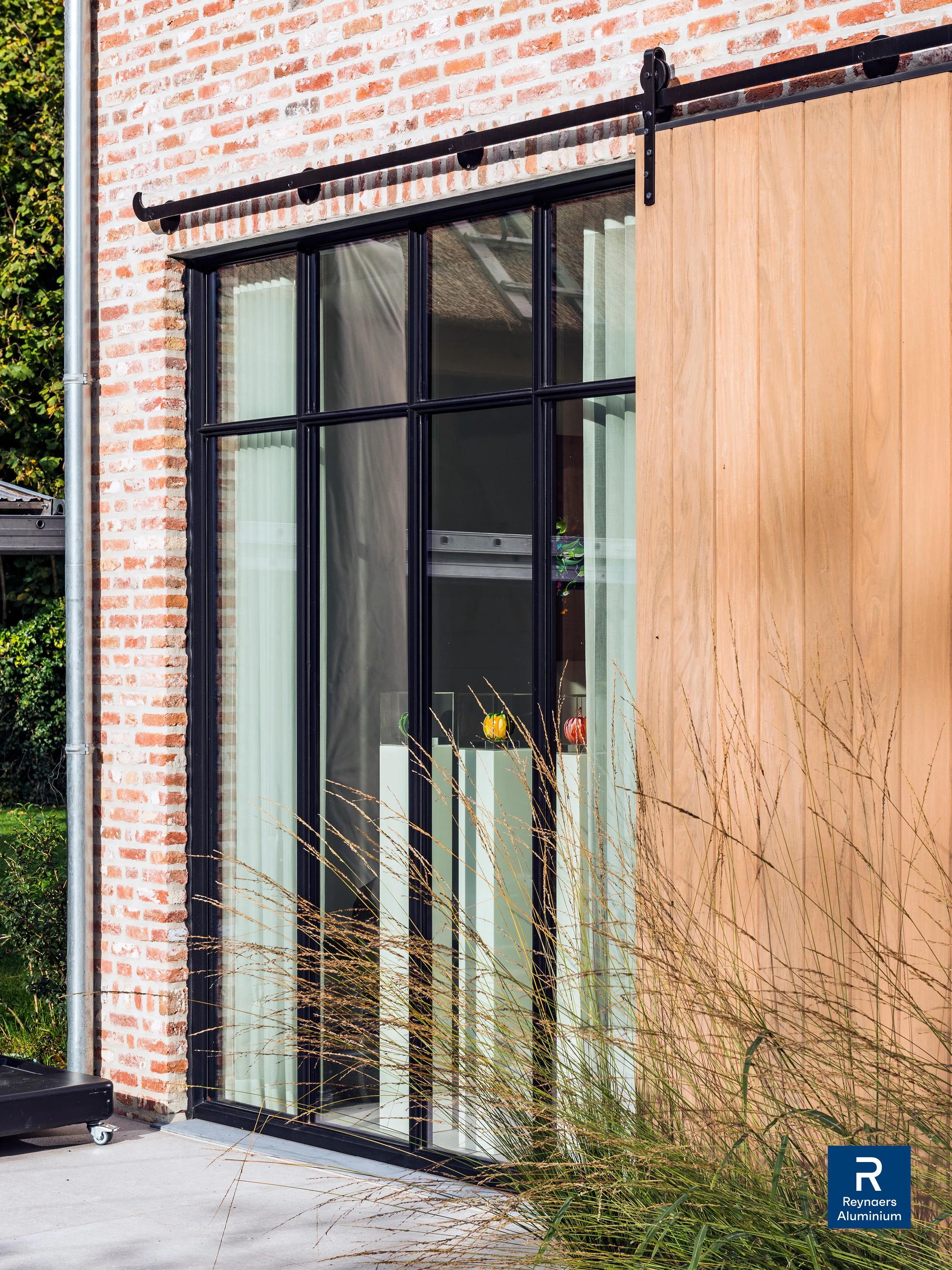 zwarte reynaers aluminium steellook raam geïntegreerd in landelijke woning door Leroy-alu