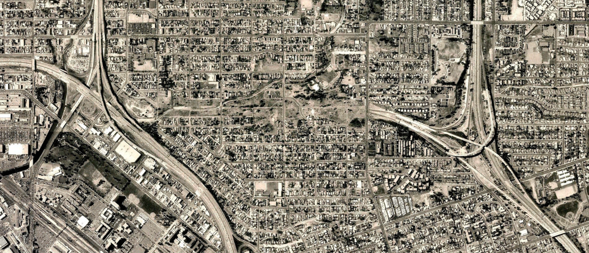 Aerial view of the SR-252 corridor in the late 1990s, showing cleared land following where the freeway was planned to be built.