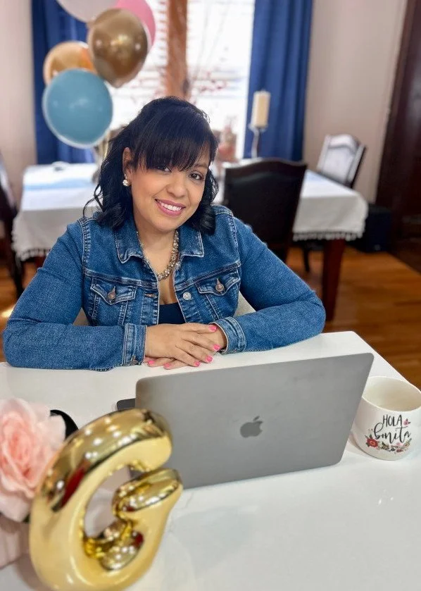 A woman with dark hair, wearing denim jacket.