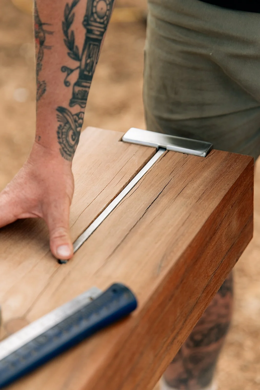 Person's hand on a piece of wood.