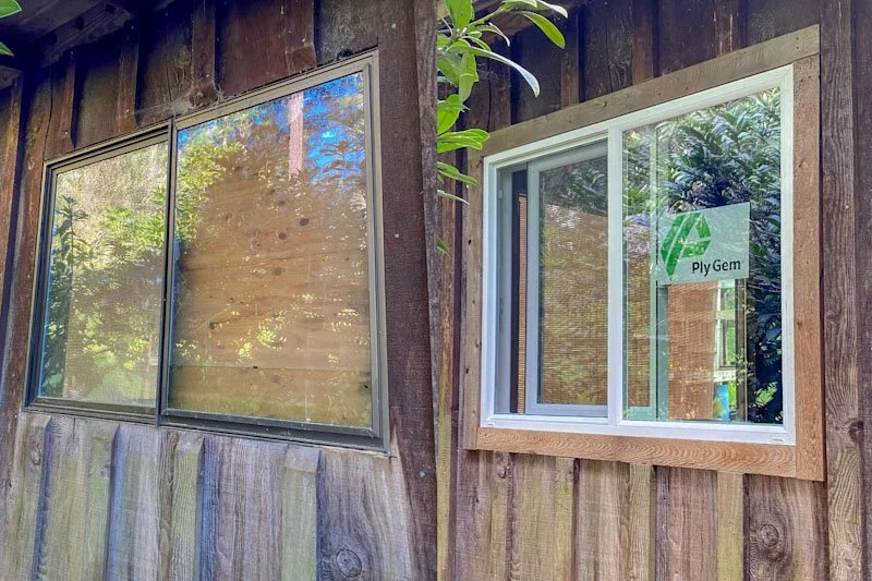 Before and after of a window replacement with trim on an exterior wall of a cabin.
