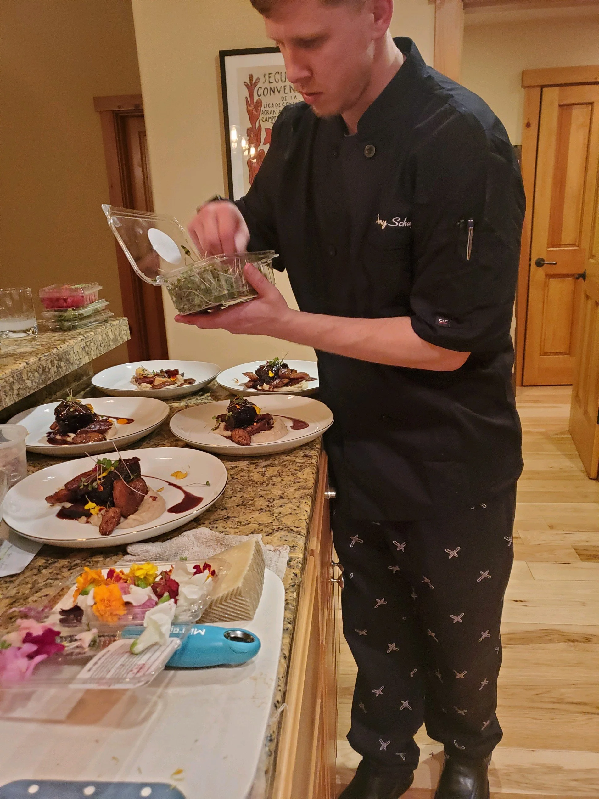 Chef plating seasonal dishes in home kitchen