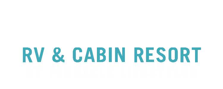 RV and cabin resort sign by Pinnacle Lifestyles with blue and white text on a black background.