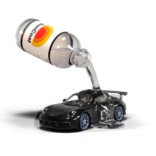 A small black toy sports car with syrup being poured onto it from a bottle labeled "sugar".