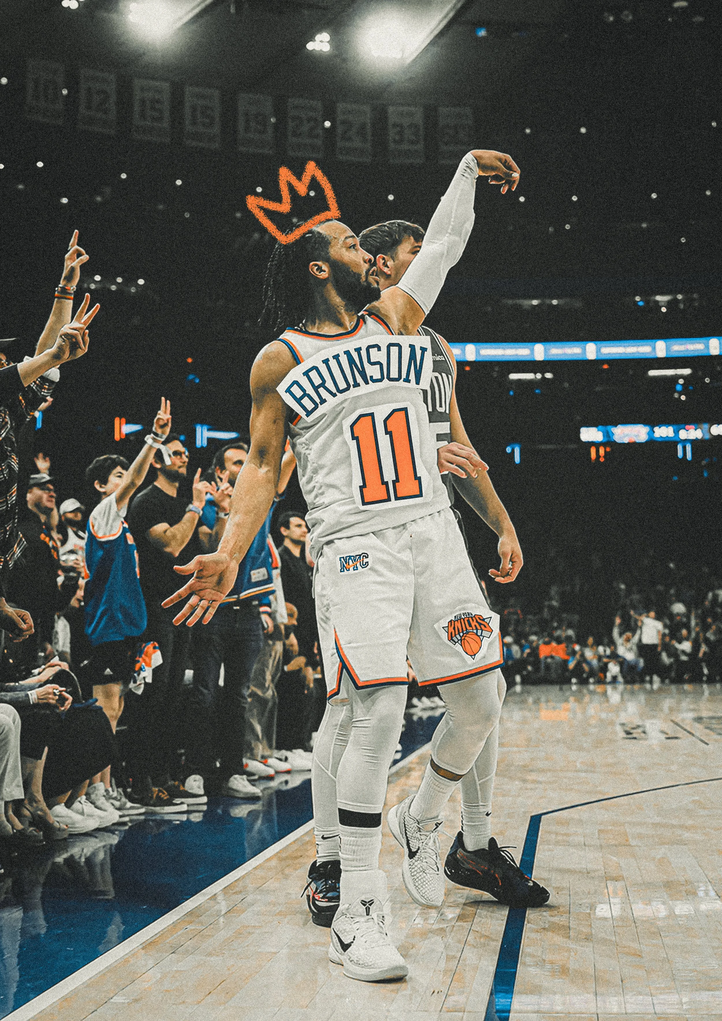 Basketball player Julius Randle from the New York Knicks celebrating on the court during a game, wearing his jersey number 11 and a crown drawn above his head, with a crowd of fans and teammates cheering nearby.