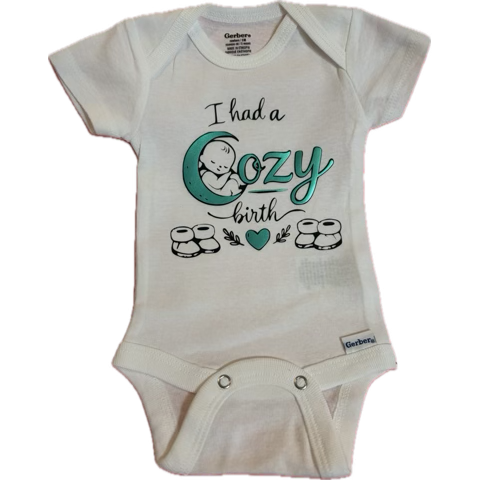 Baby white onesie with a print that says, 'I had a cozy birth' with a moon and sleeping baby illustration, and small drawings of rolls.