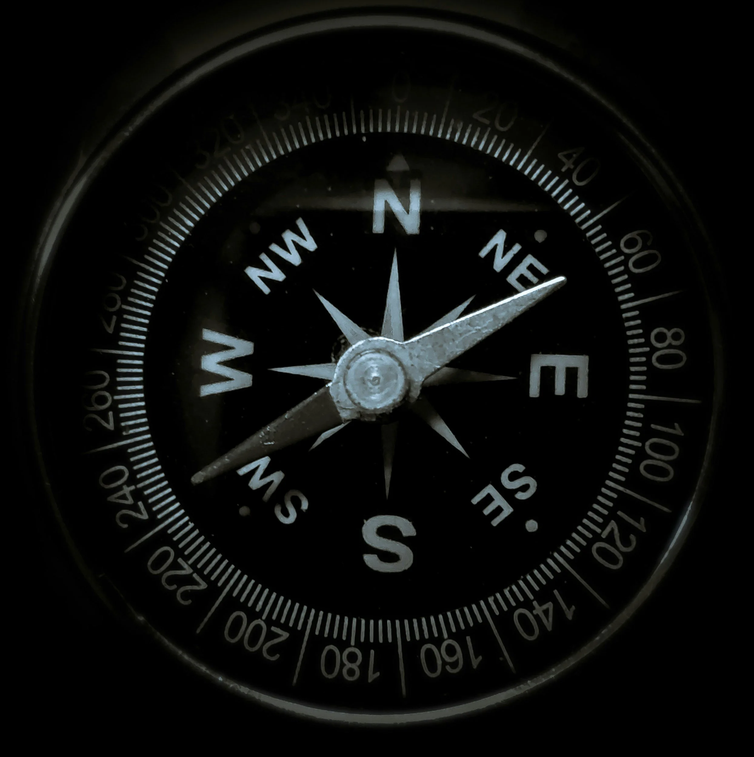 A compass showing north-east direction with the needle pointing towards NNE.