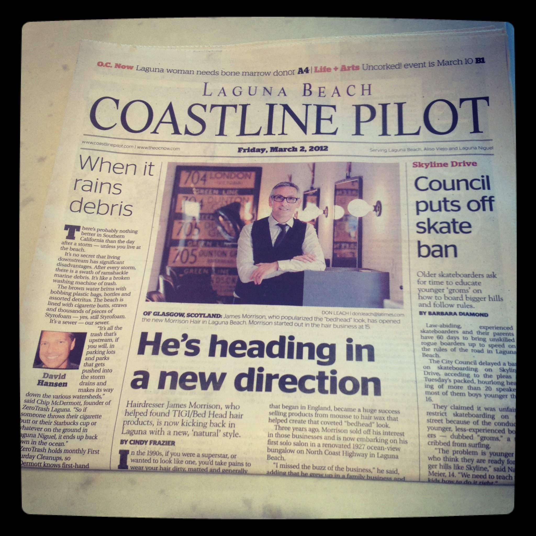 Front page of the Laguna Beach Coastline Pilot newspaper dated March 2, 2012, featuring a headline about James Morrison and his hair business, with a photo of him smiling in front of framed pictures and a headline about skateboard skate ban.