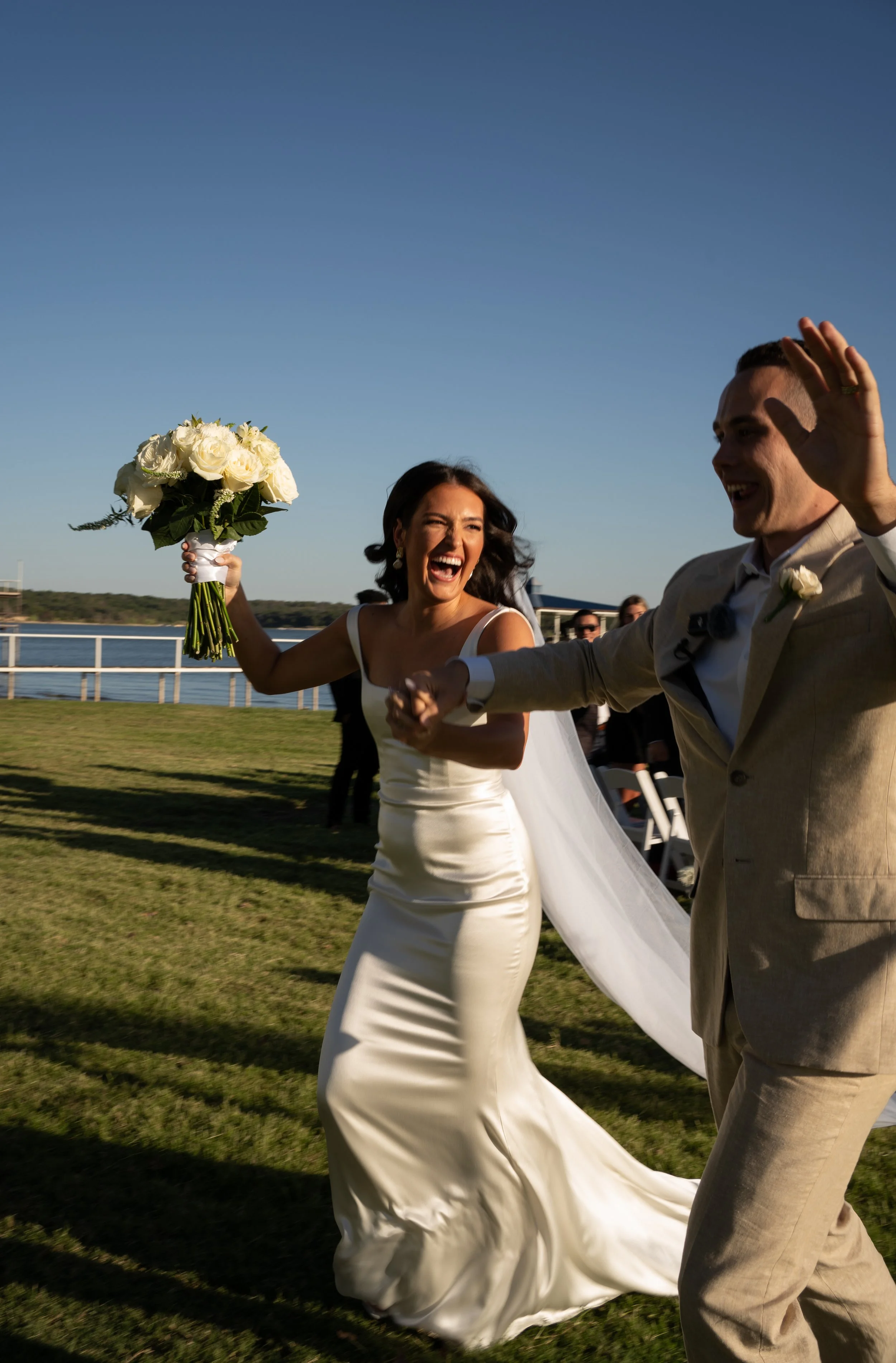 Joyful bridal and groom celebrating after ceremony during a backyard bakehouse wedding in Fort Worth, Texas.