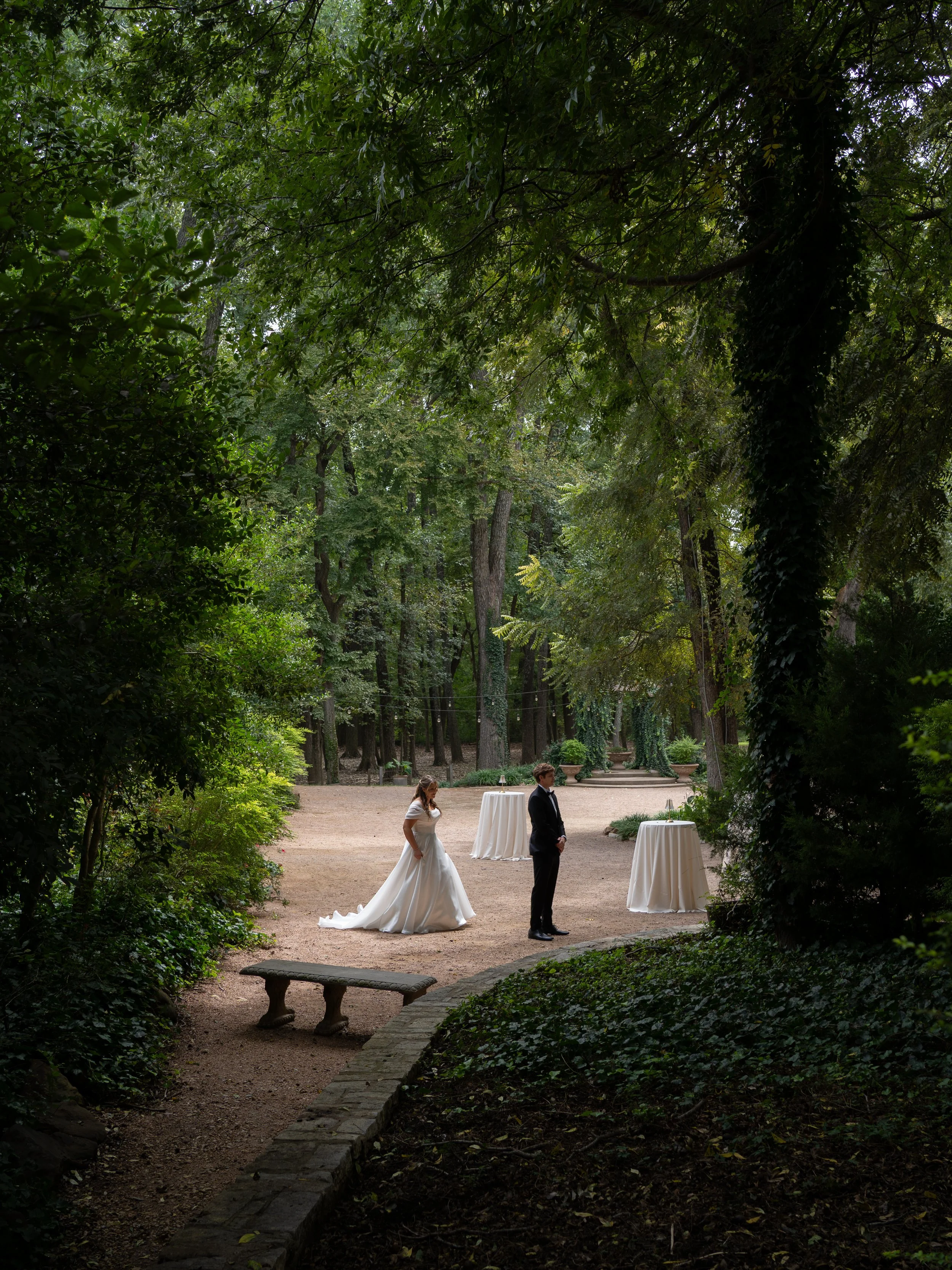 Outdoor wedding first look surrounded by trees in Waxahachie Texas with couple standing together
