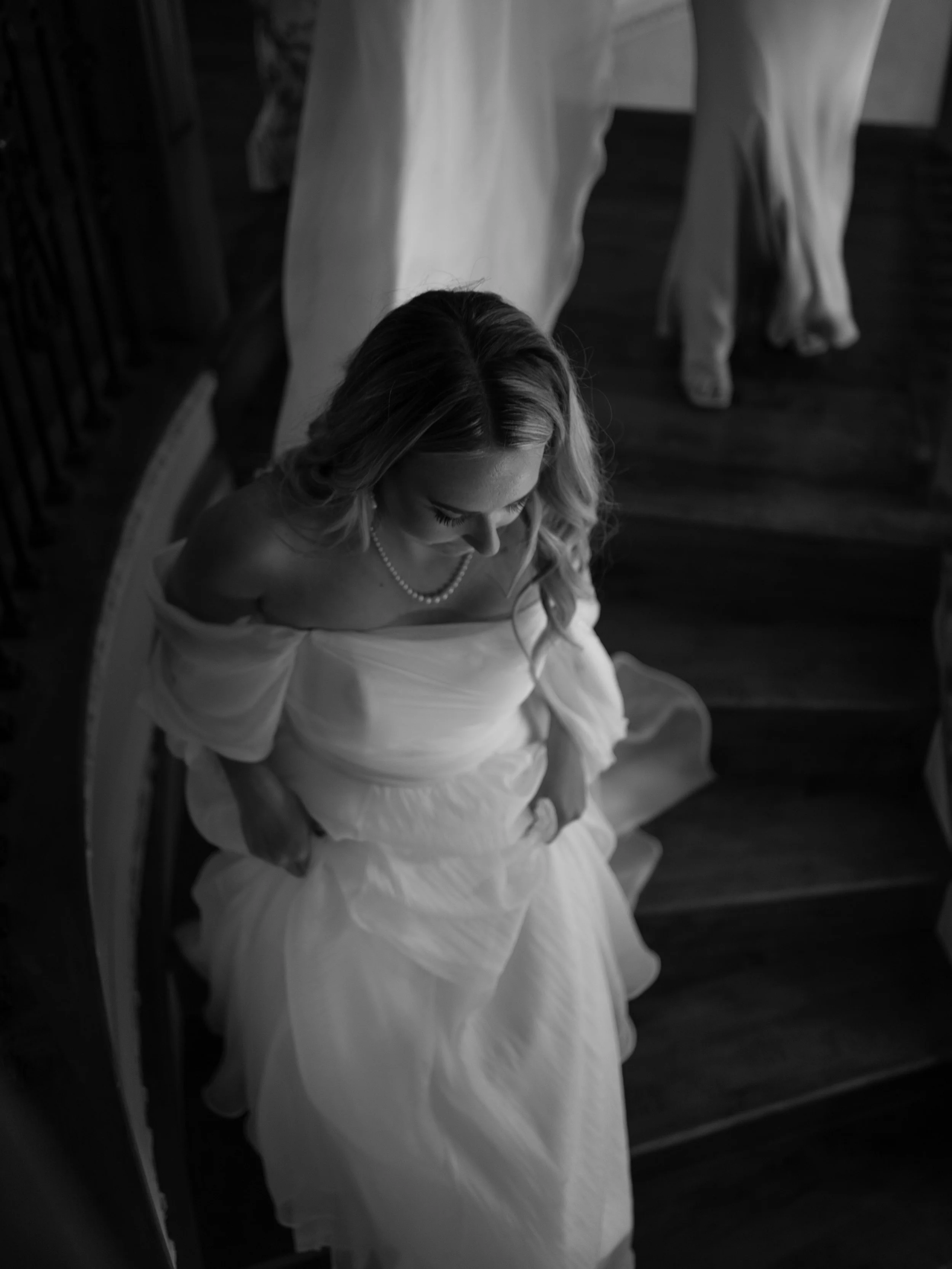 Bride walking downstairs in dress