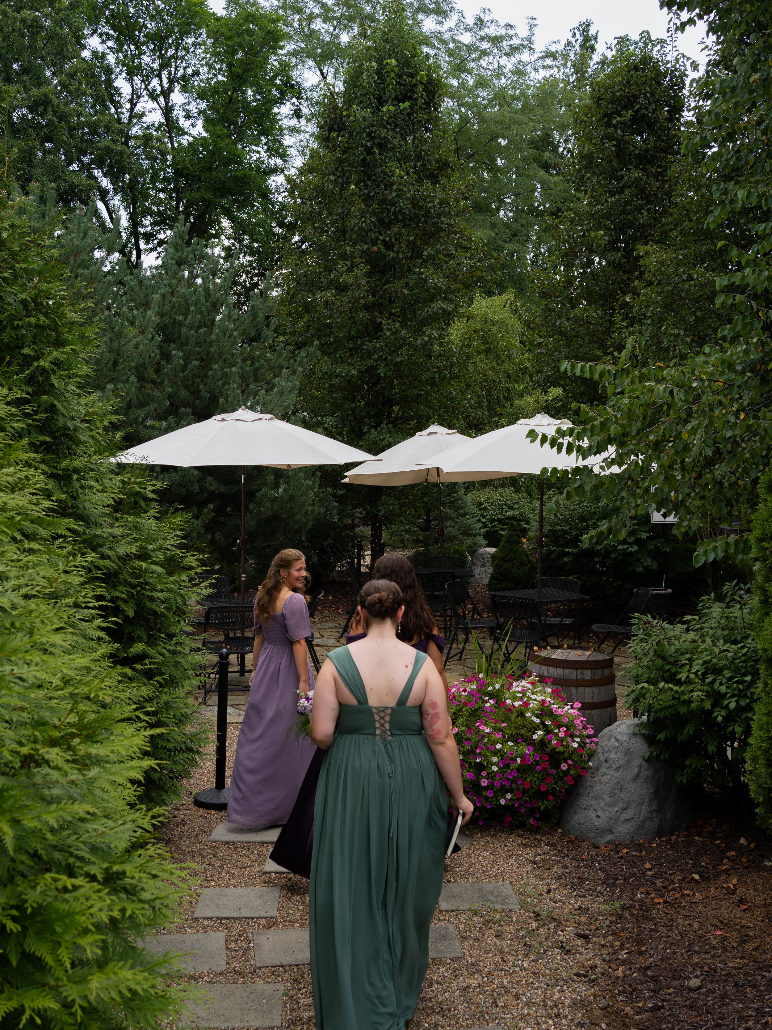 Guests gather in an outdoor reception space in O’Fallon, Missouri, surrounded by greenery and floral details.
