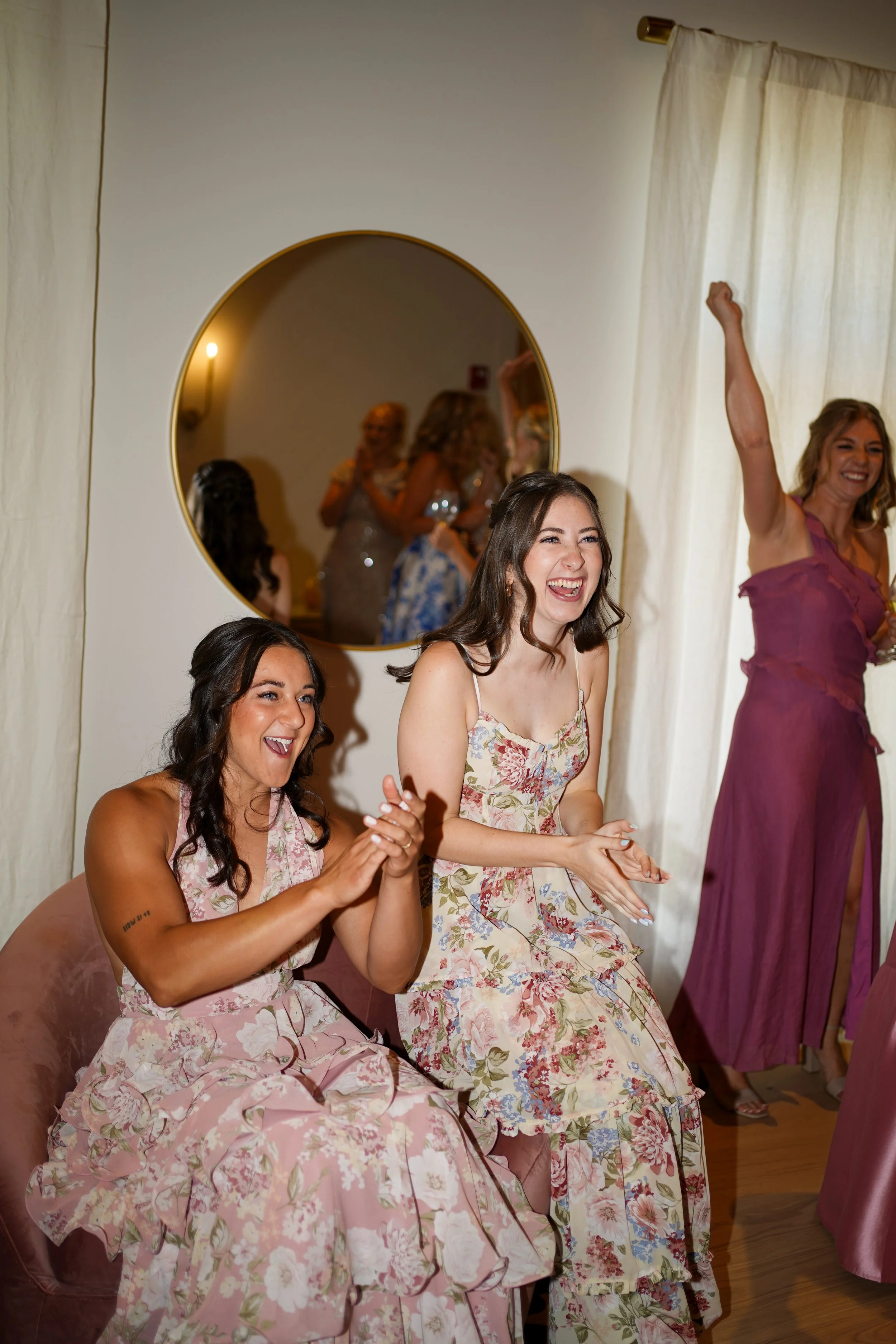 Candid documentary bridesmaids revel of bride in dress