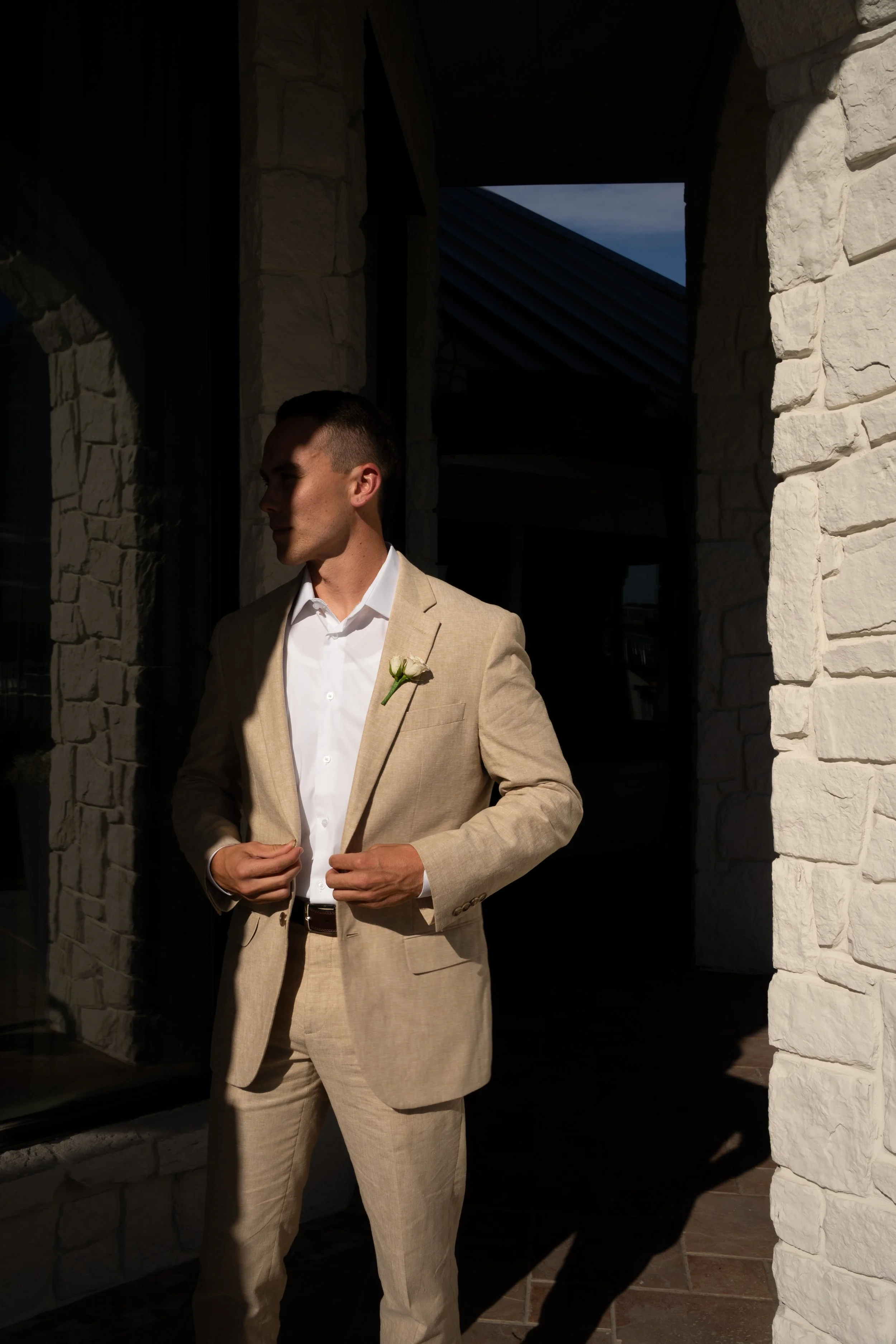Editorial portrait of the groom in soft natural light during a backyard tent wedding in Fort Worth, Texas.