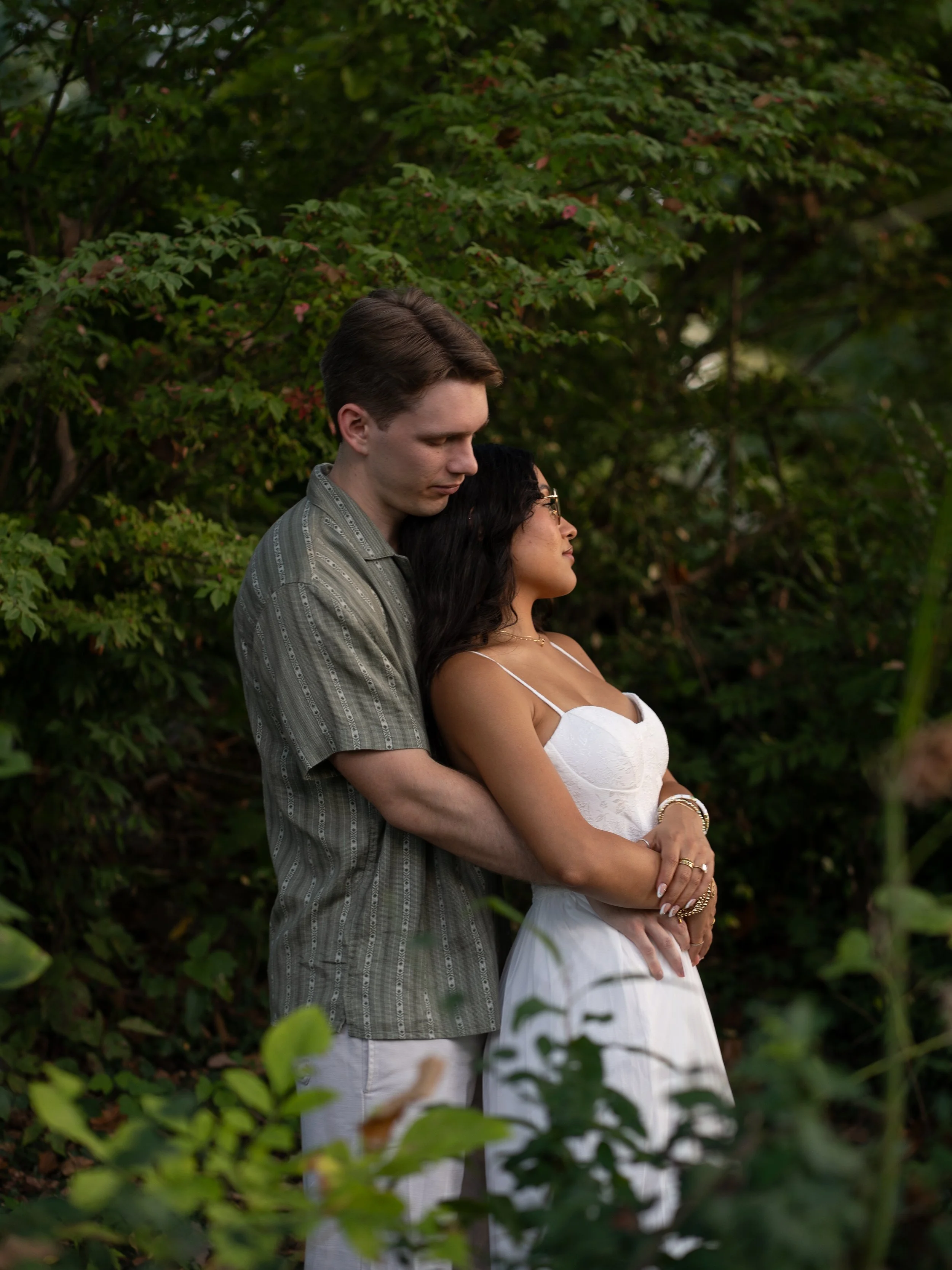 A soft and romantic portrait in Mammoth Springs, AR, framed by lush greenery and natural textures.
