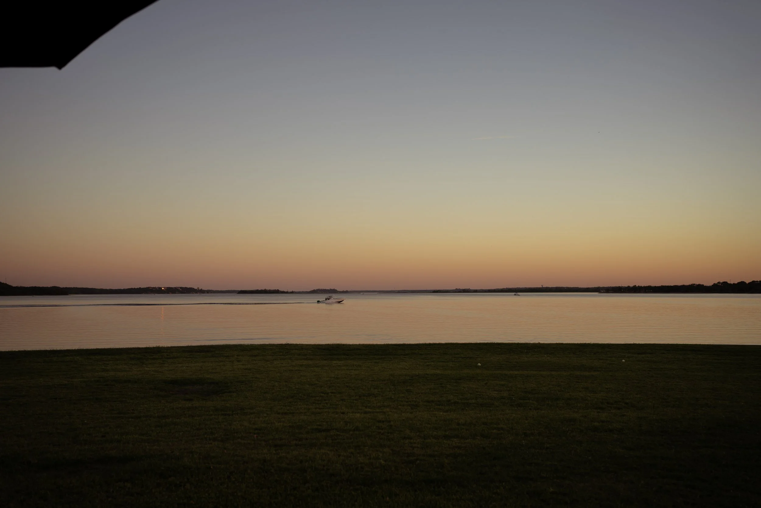 Golden sunset over the Texas landscape during an intimate backyard lake house wedding in Fort Worth.