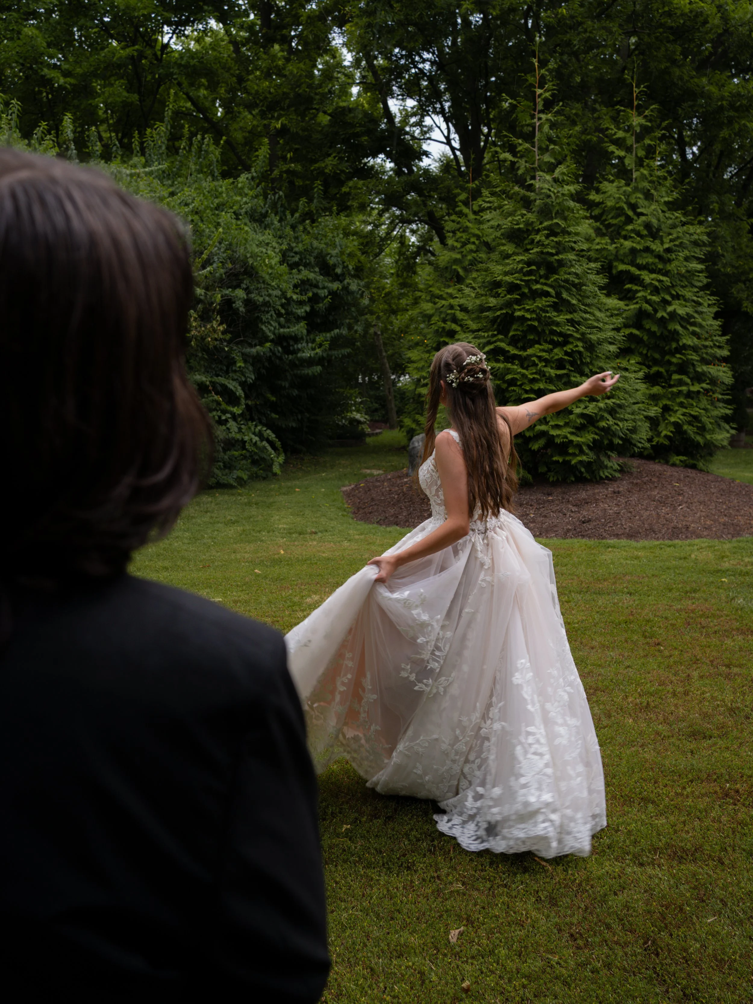 A graceful bridal portrait in O’Fallon, MO, capturing movement and lightness within a garden setting.