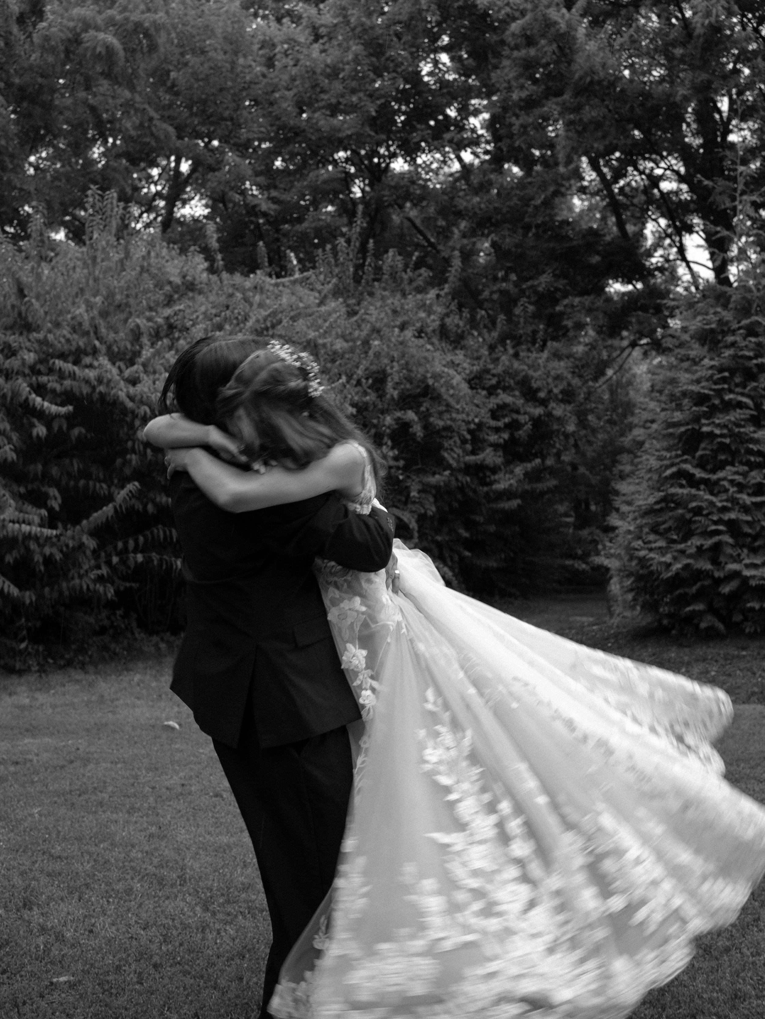 A cinematic black-and-white first look in O’Fallon, MO, capturing emotion and movement as the couple embraces.