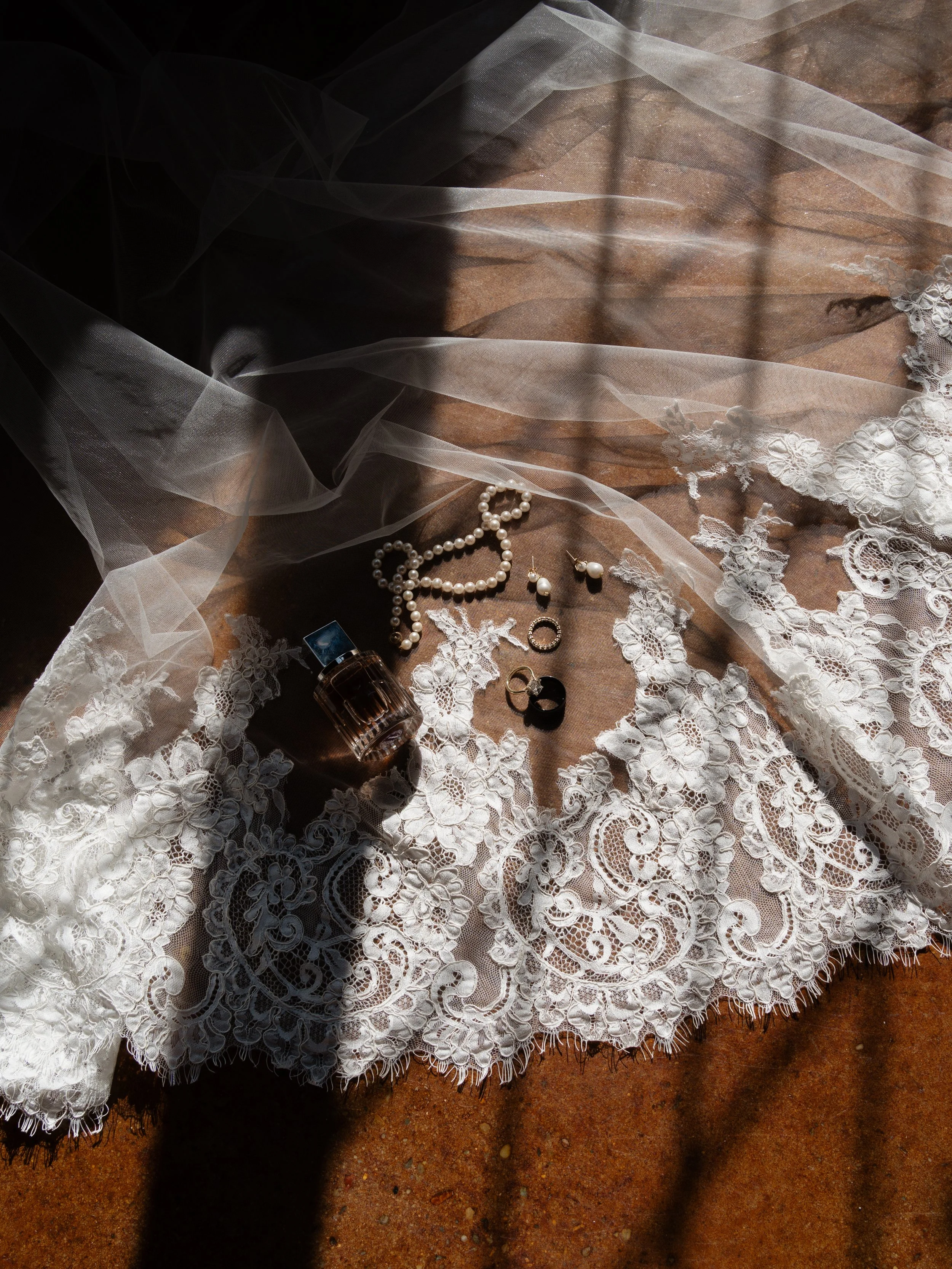 A delicate bridal detail composition in Montgomery, Texas, featuring lace textures, heirloom jewelry, and soft, romantic styling.