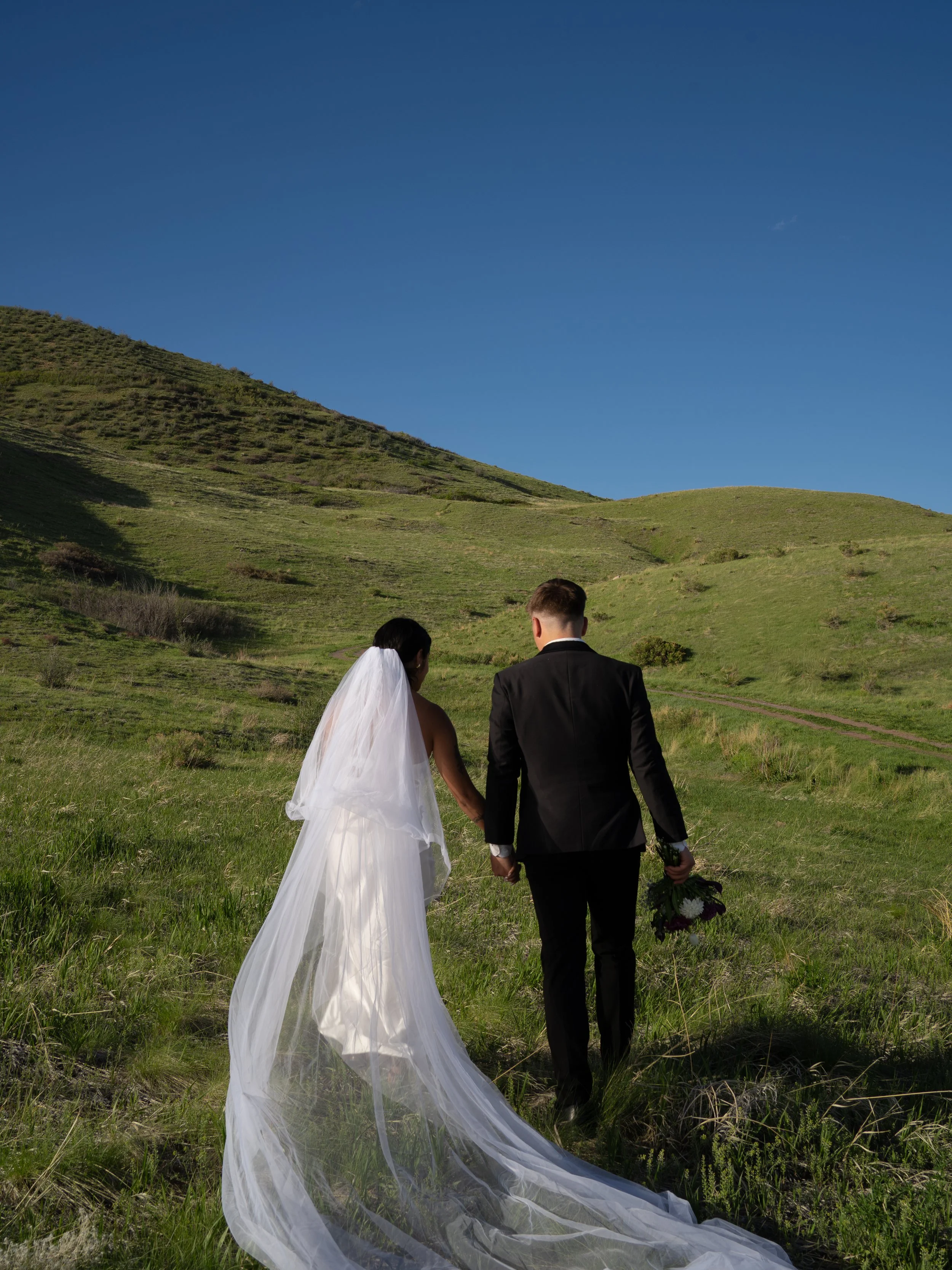 A peaceful, storytelling-driven moment in Boulder, Colorado, as the couple walks together through open space.