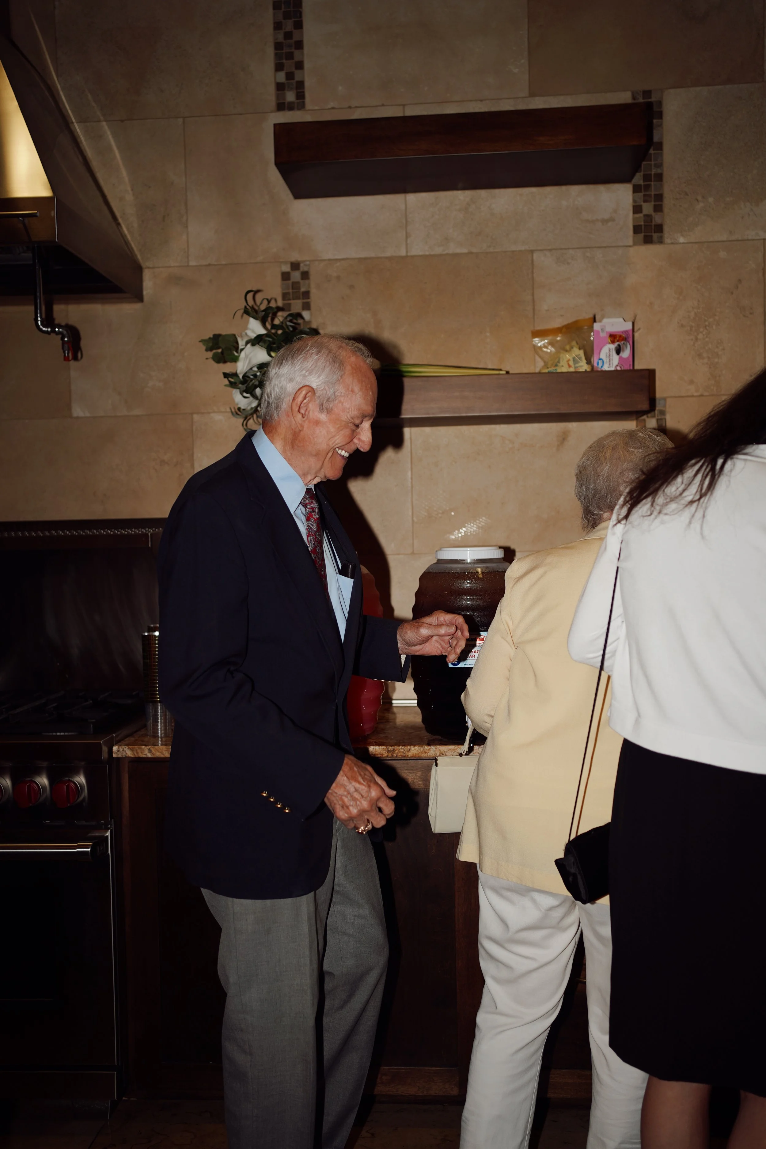 A candid guest moment in Richmond, TX, capturing connection and quiet interaction during the celebration.