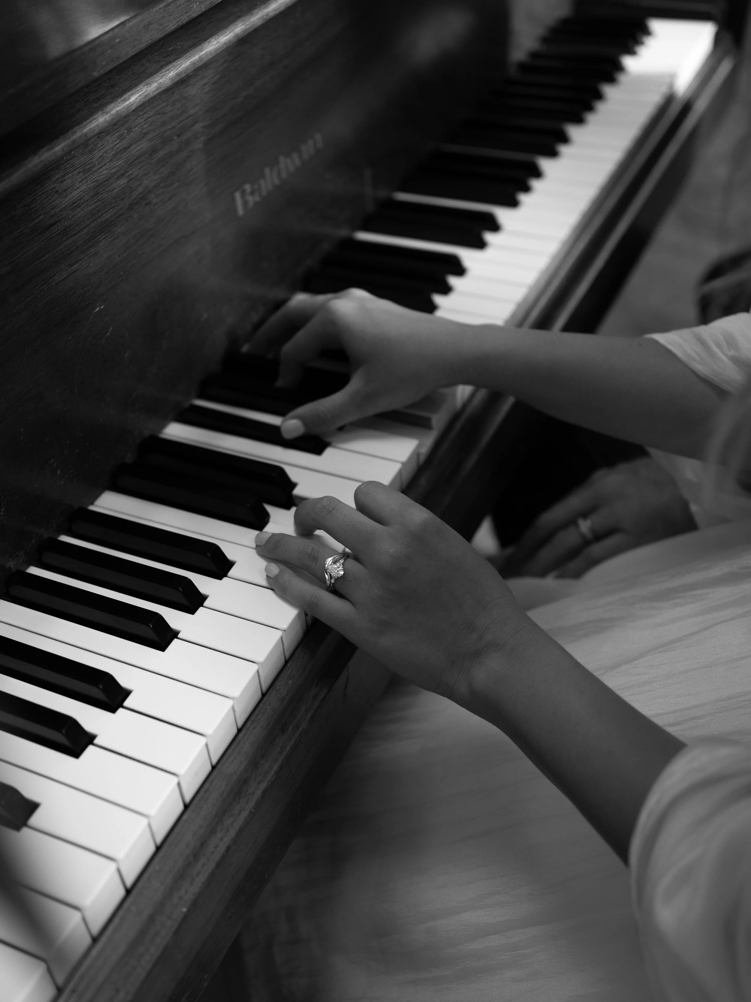 Bride and engagement ring playing piano 