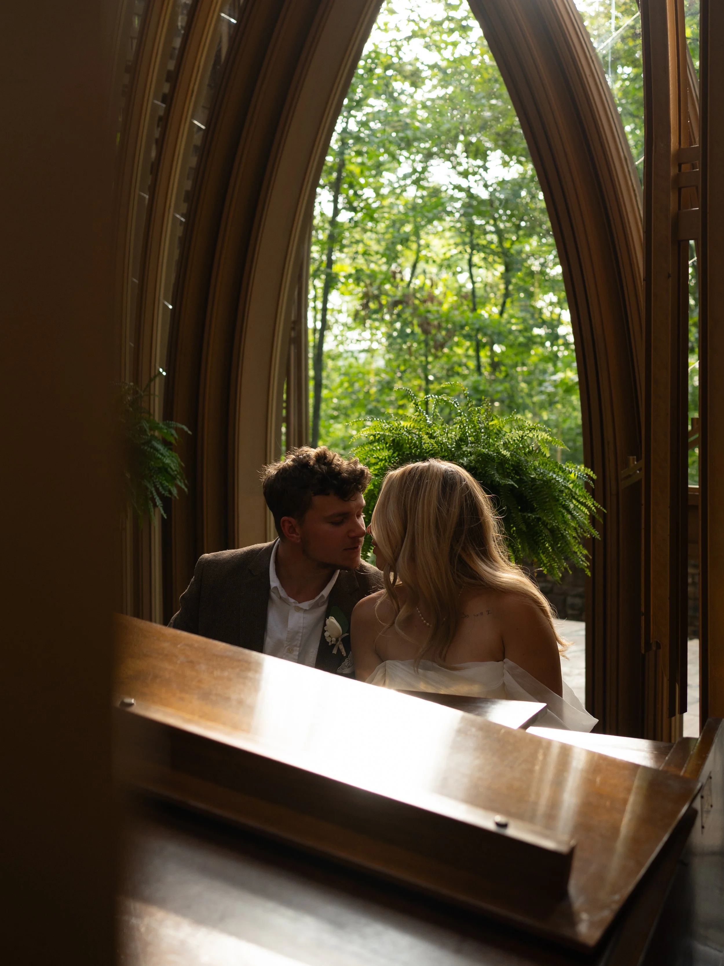 Couple sharing a quiet moment inside Mildred B. Cooper Memorial Chapel in Bella Vista, Arkansas