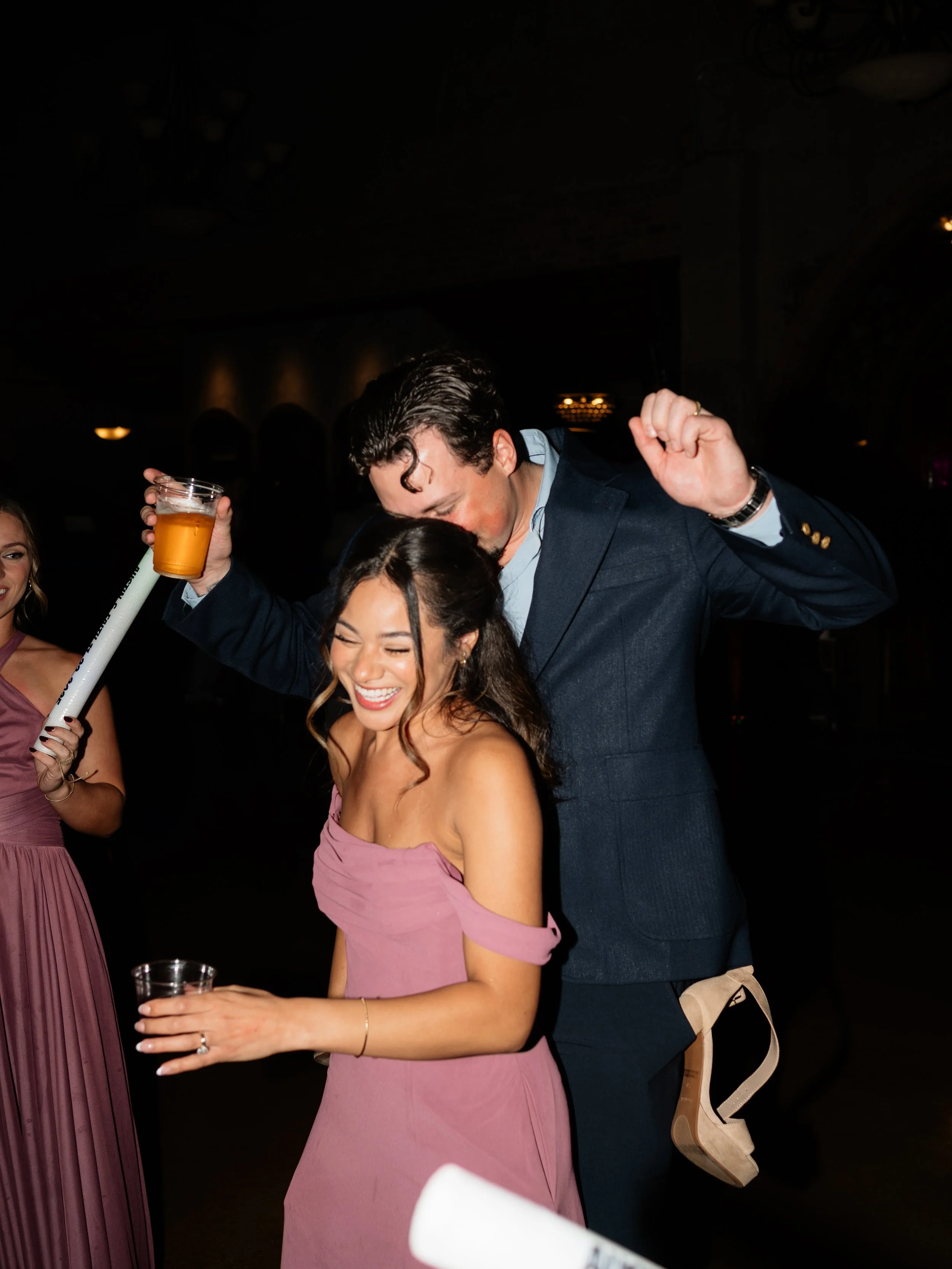 A lively reception moment in Montgomery, TX, where guests and the groom celebrate on the dance floor with candid joy and movement.