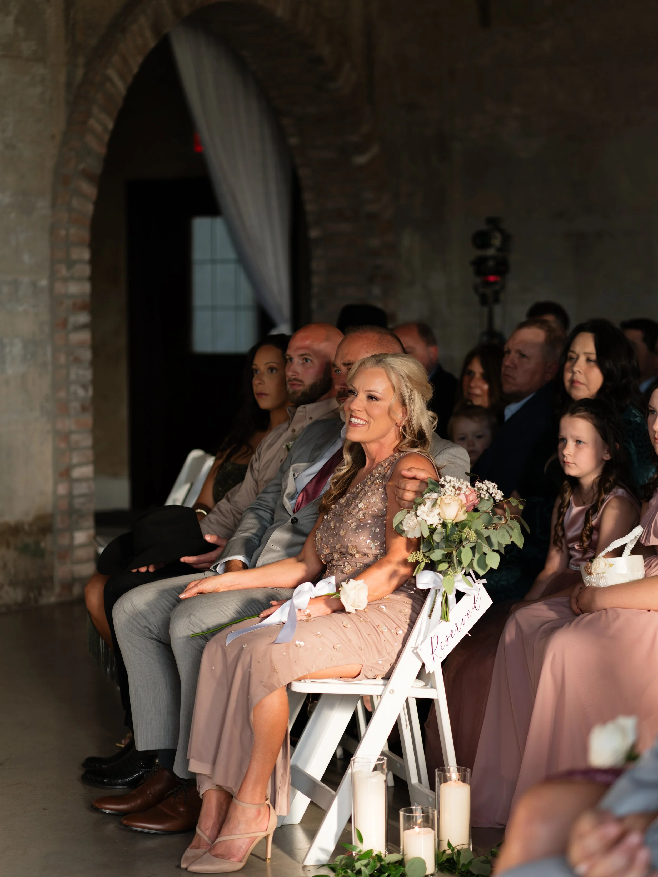 Family and guests look on during a Montgomery, Texas wedding ceremony, capturing quiet emotion and meaningful connection.