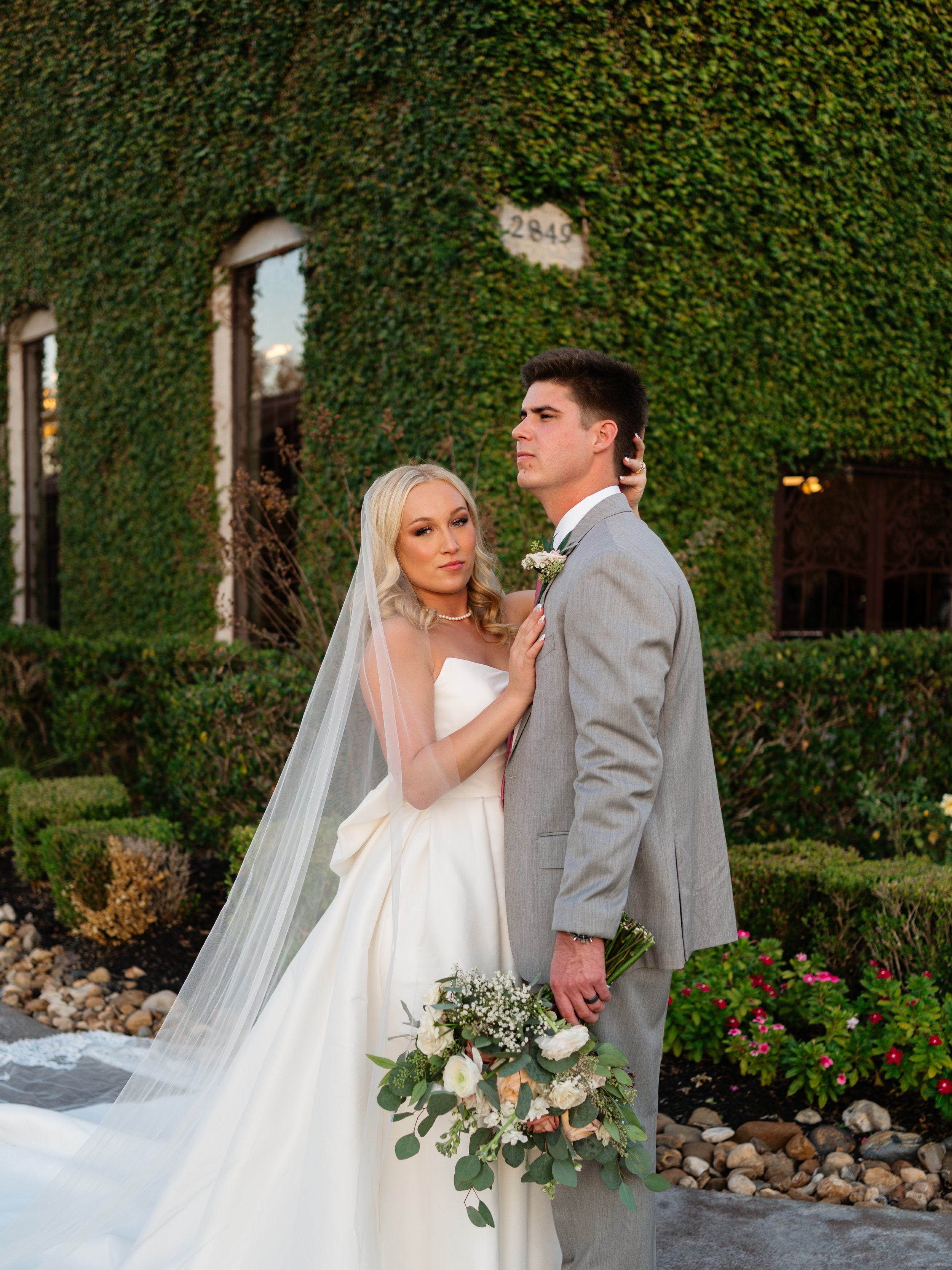 A natural and romantic couple’s portrait captured in Montgomery, TX, surrounded by lush greenery and soft evening light.