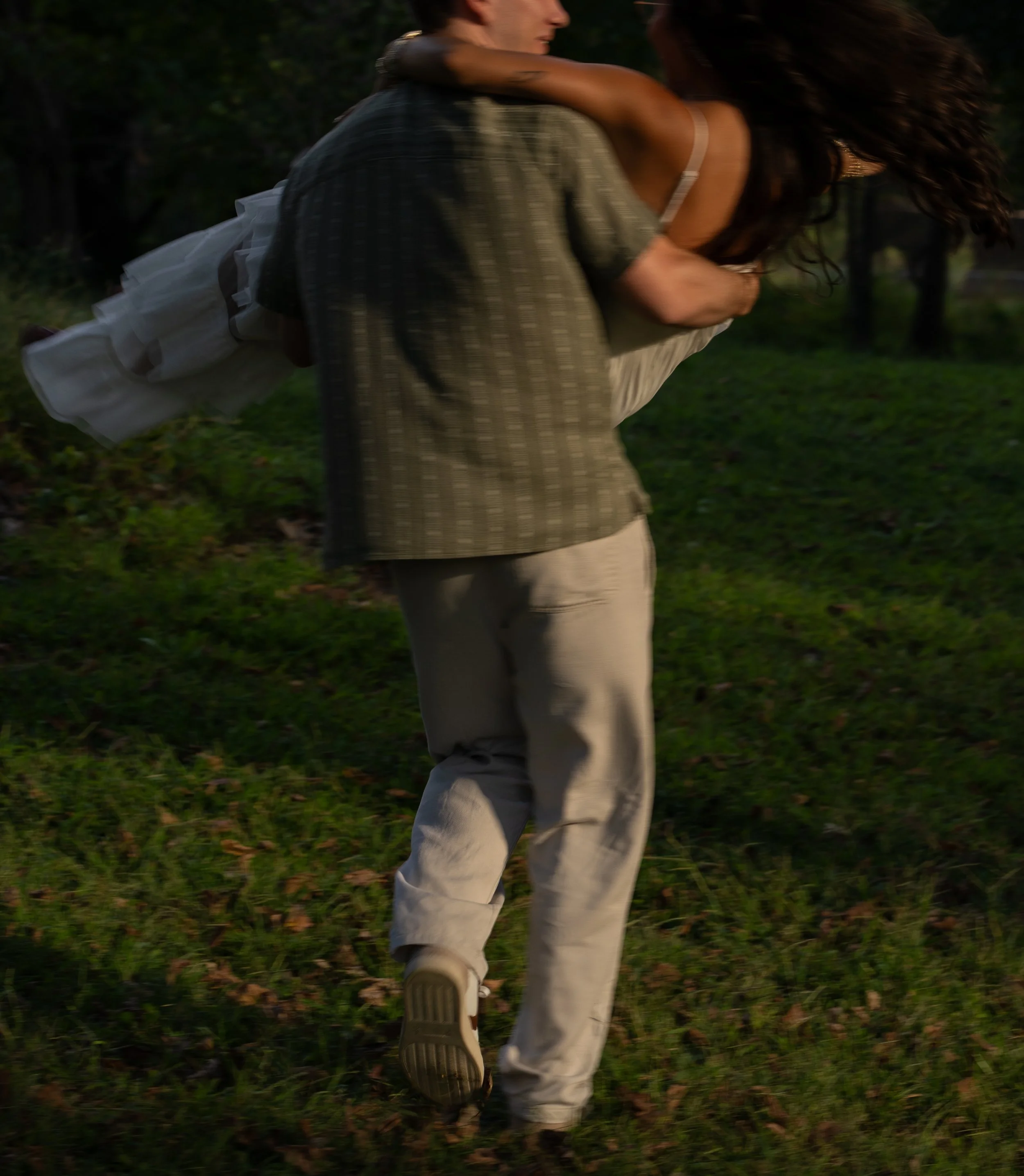 A dynamic engagement moment in Mammoth Springs, AR, capturing motion and spontaneity as the couple moves through the landscape.