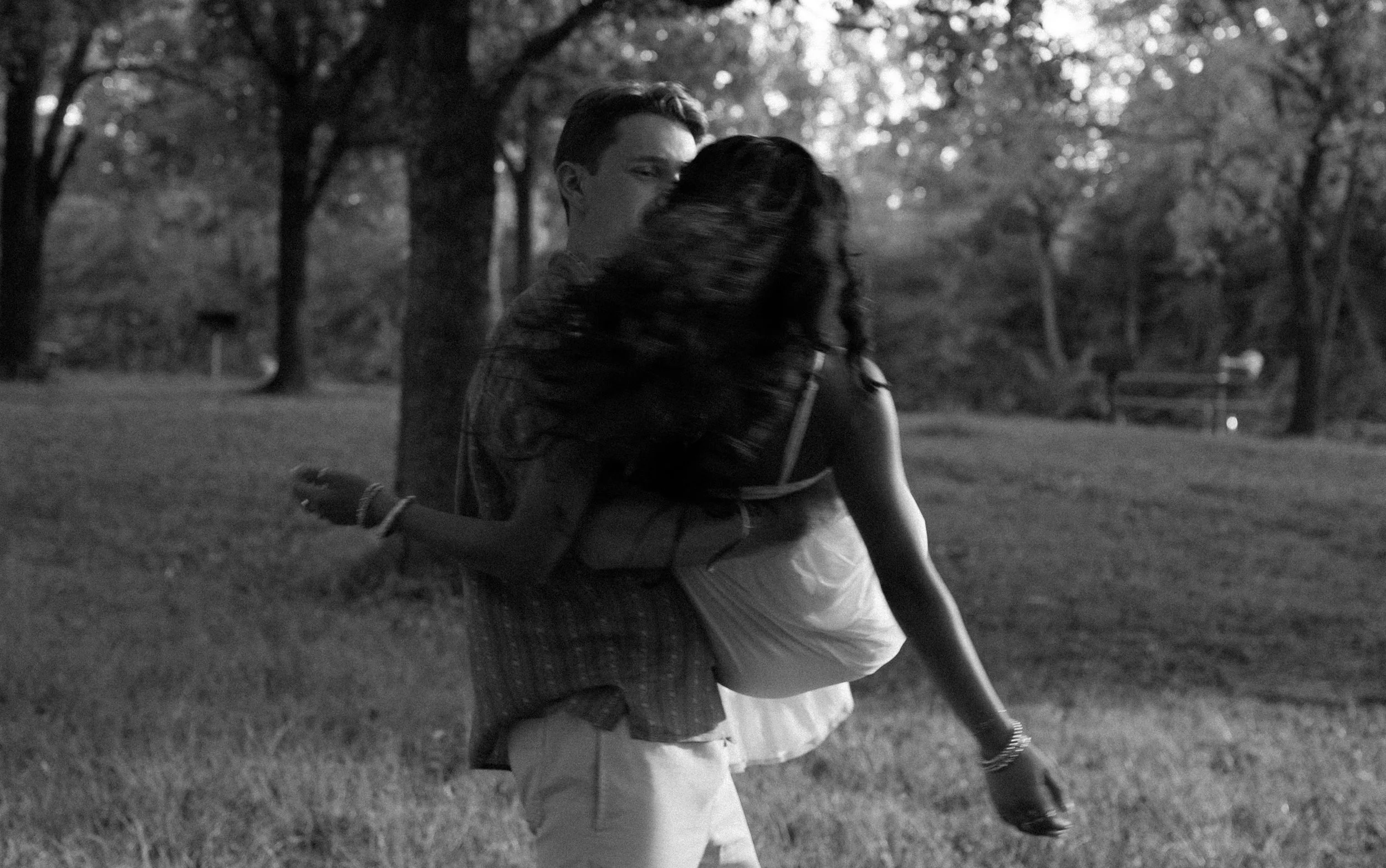 A joyful black-and-white moment in Mammoth Spring, Arkansas, capturing movement and carefree connection.
