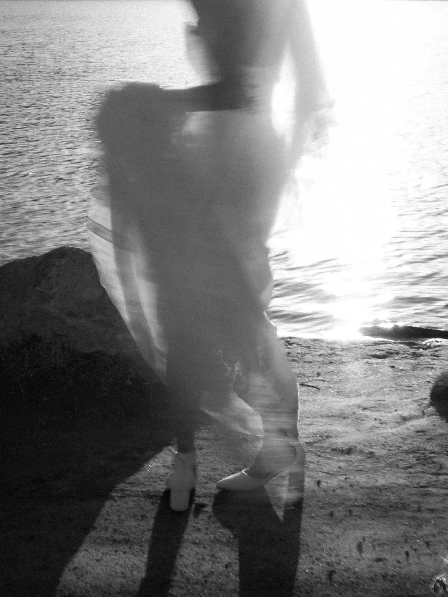 Artistic motion blur of a bride by the water during a wedding in Colorado Springs Colorado