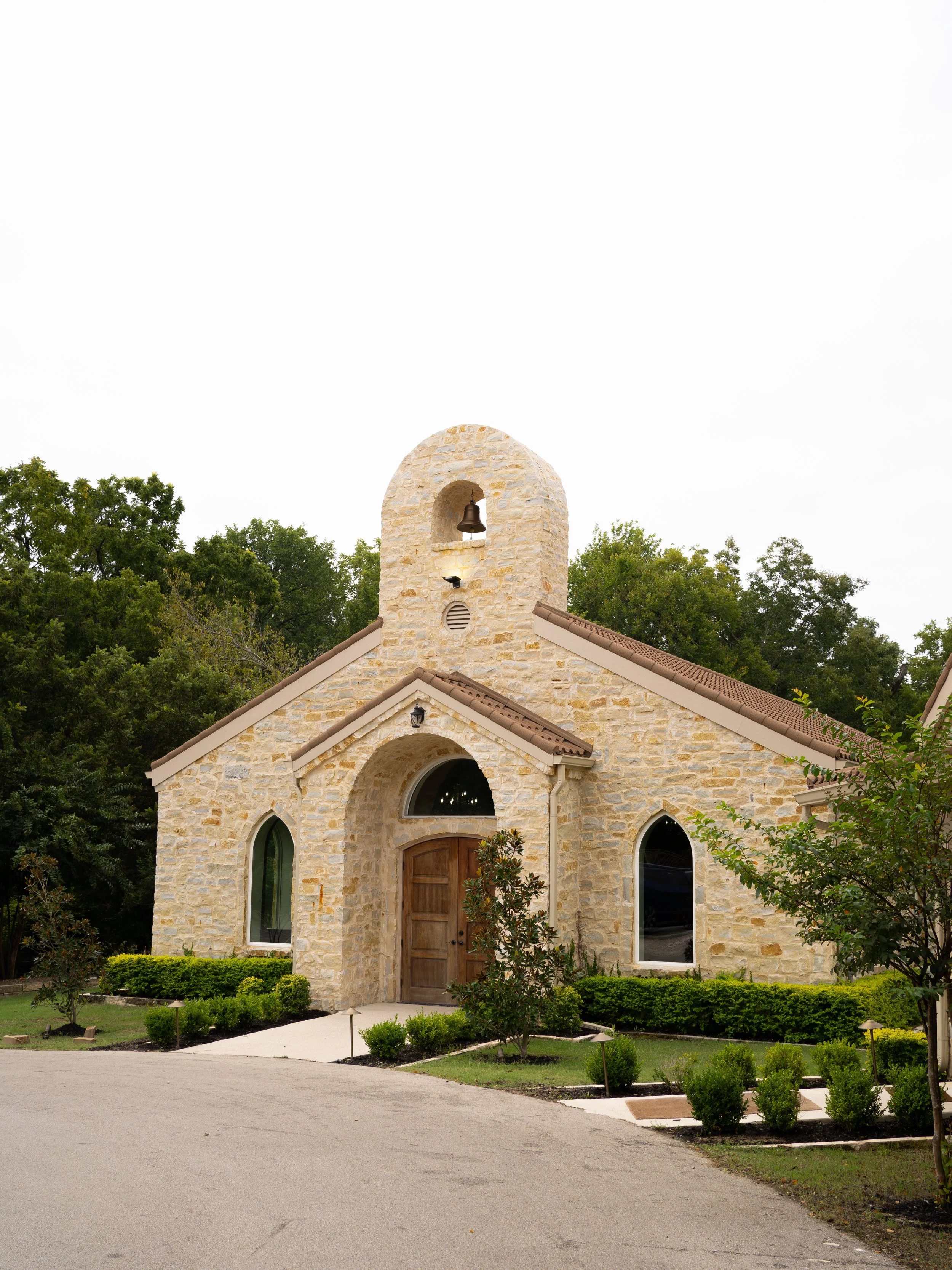 A charming chapel exterior at The Springs in Waxahachie, TX, surrounded by greenery and natural light, setting the tone for a romantic ceremony.
