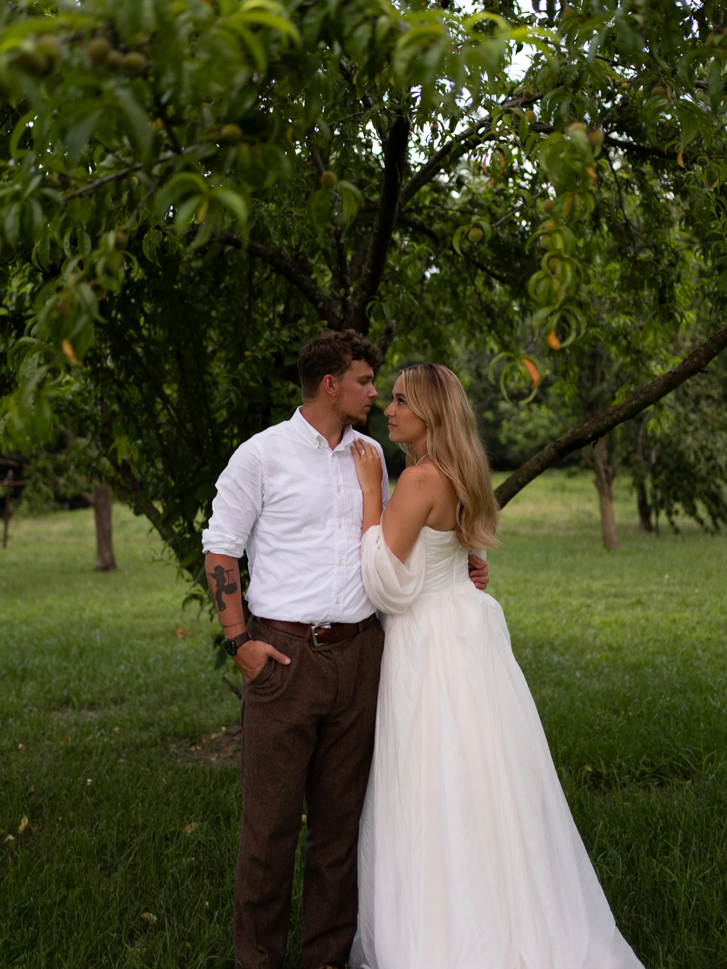 Bride and groom wedding portraits in lush green field