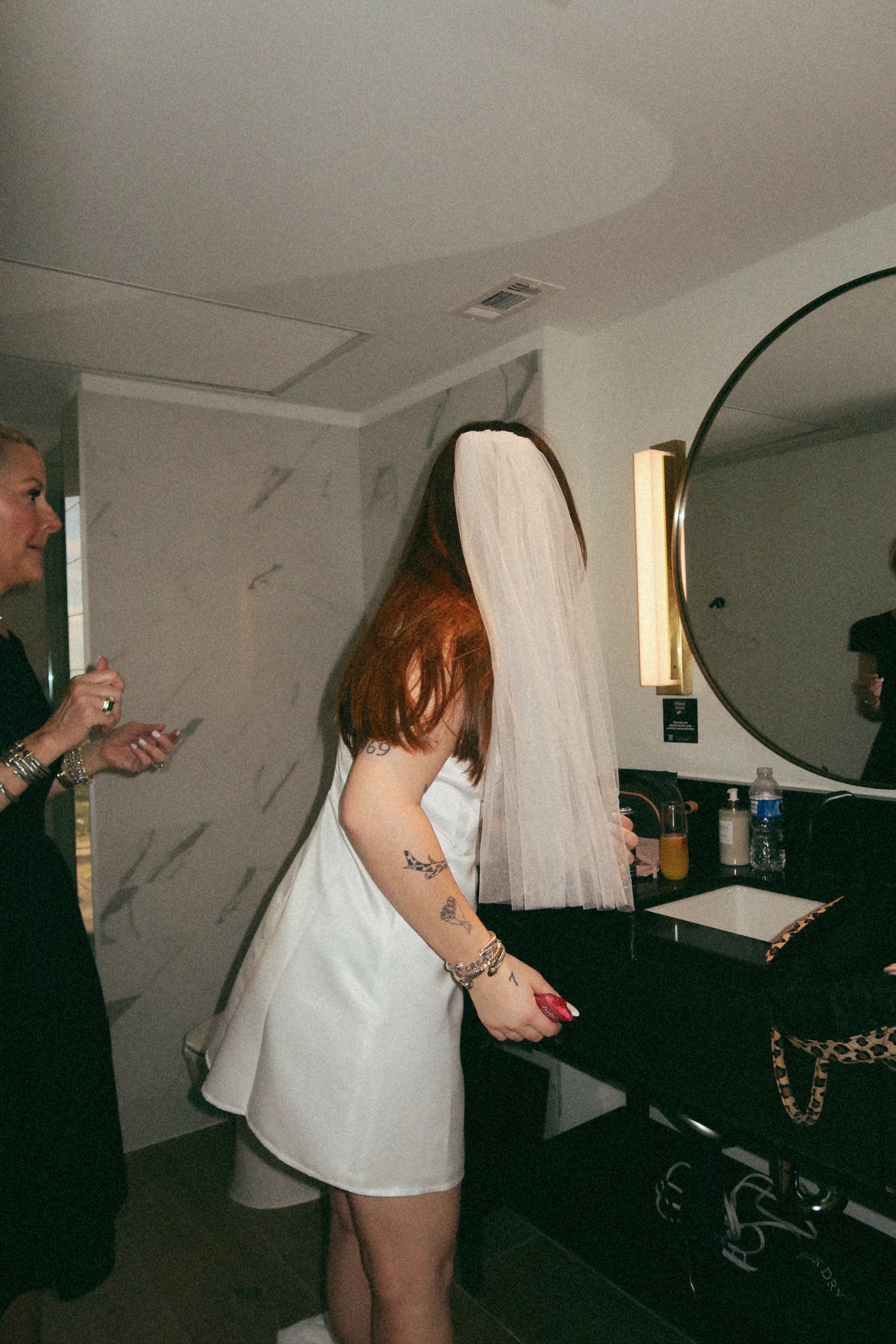 A natural bridal moment in Houston, Texas, as the bride moves through the getting-ready space with soft, unposed elegance.