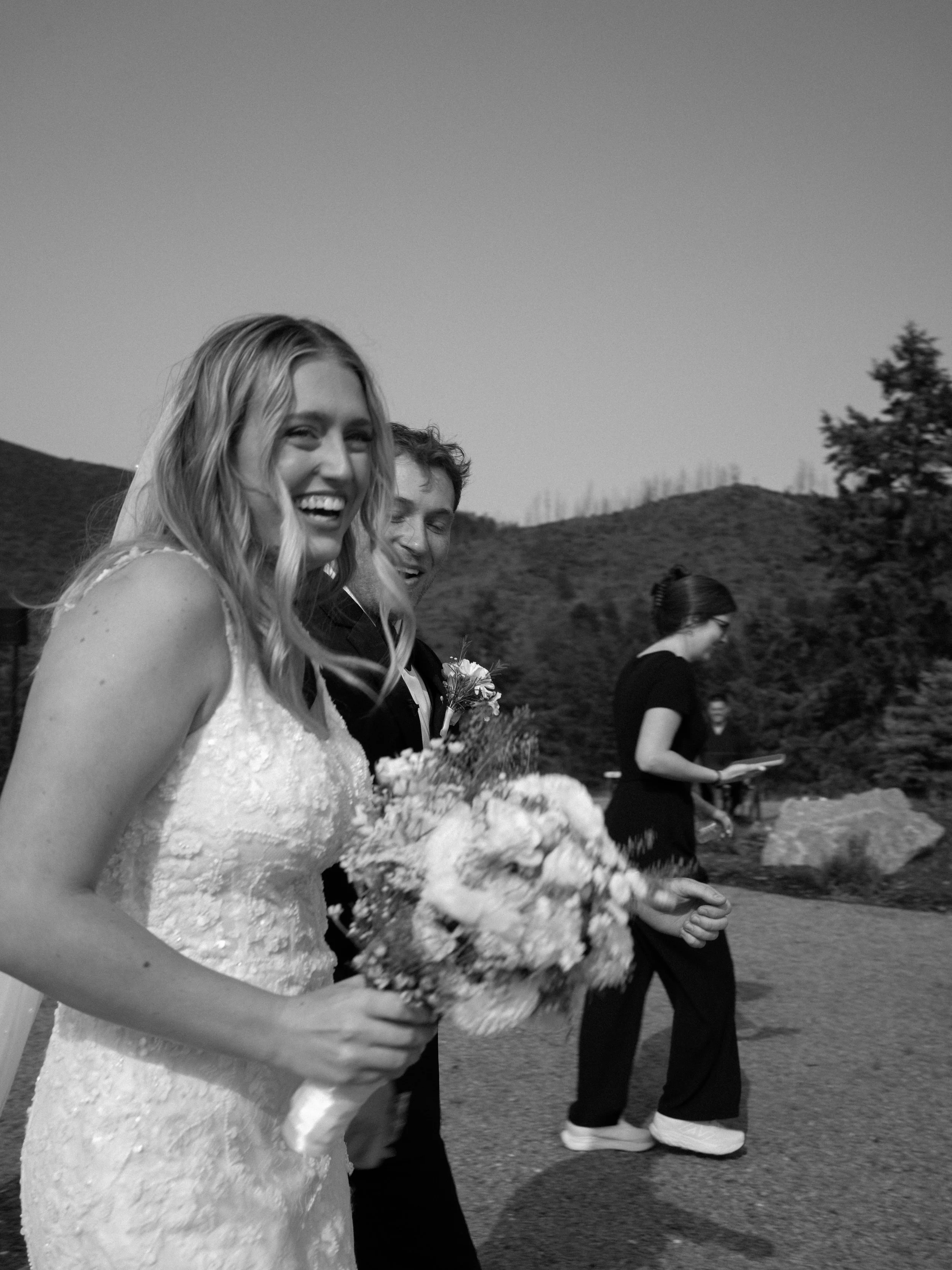 A candid moment at Pikes Peak Ranch, capturing laughter and connection among the bridal party.