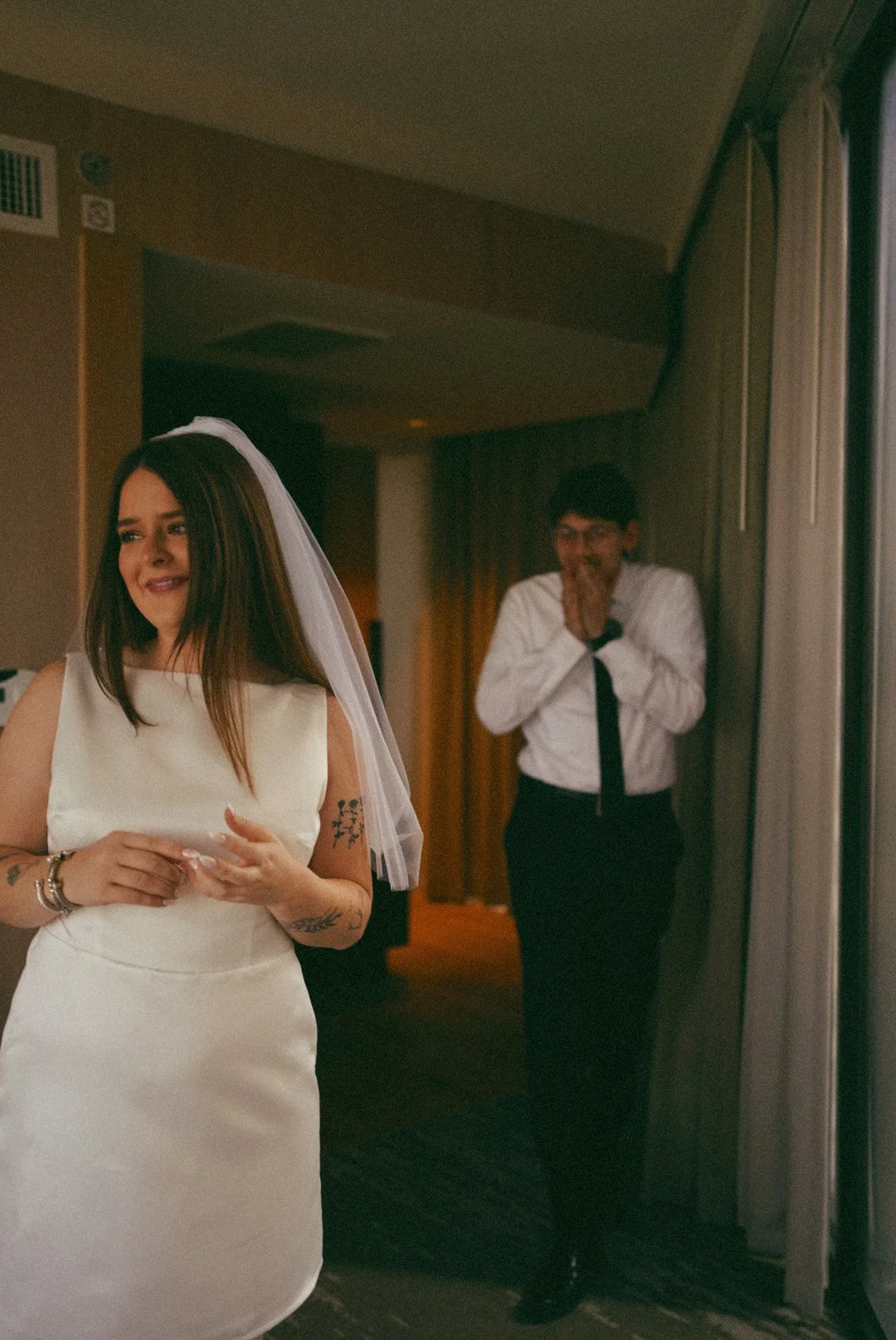 A soft, candid bridal moment of fist look in Houston, TX, as the bride prepares with natural light and quiet anticipation.
