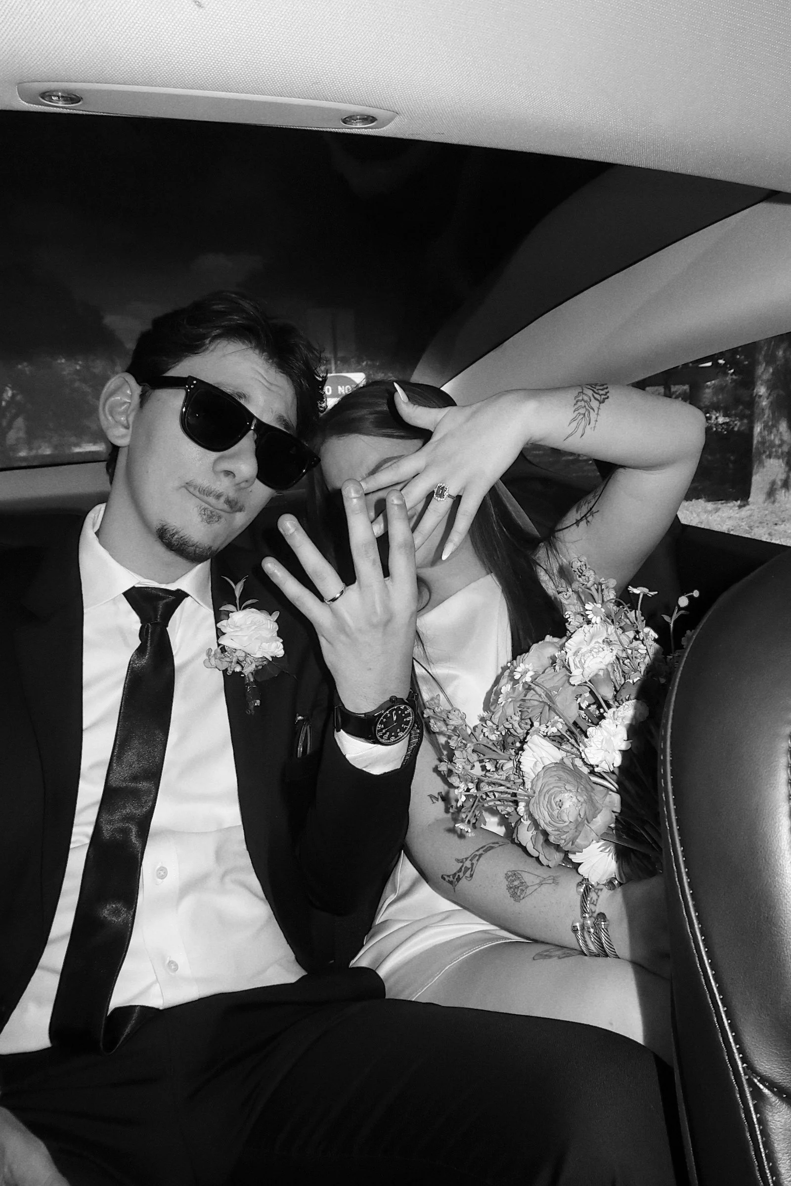 A candid black-and-white moment of the couple in Houston, Texas, capturing personality and playful connection during a quiet in-between.
