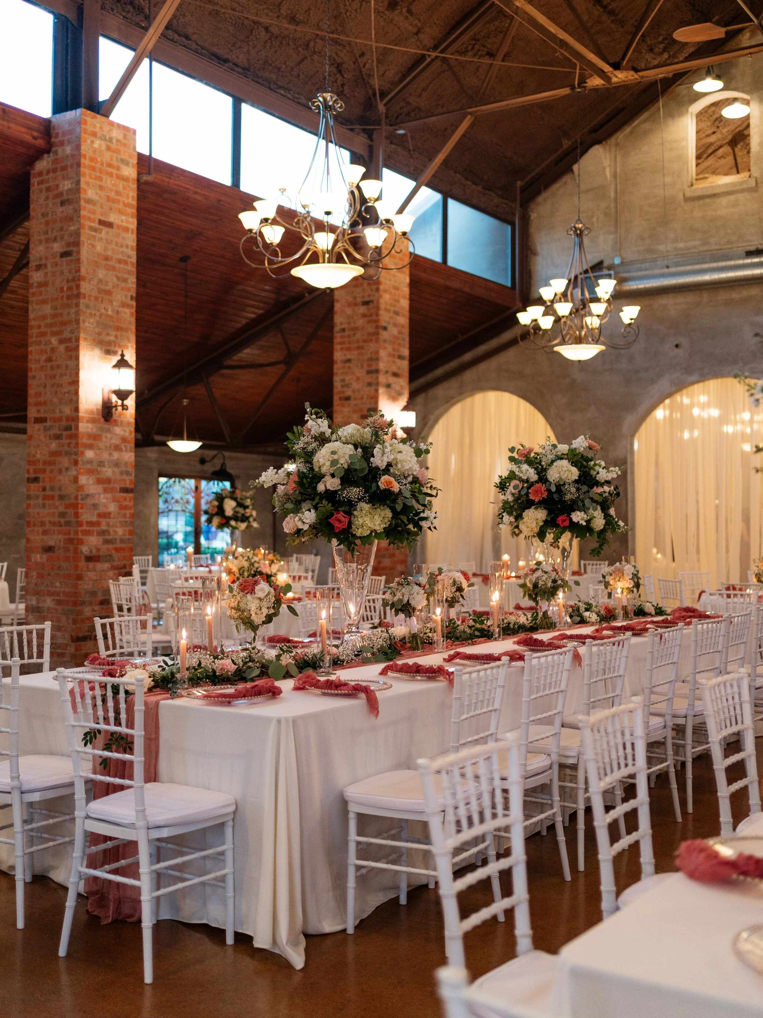 An elegant reception setup in Montgomery, Texas, featuring refined florals, warm lighting, and intentional design details.