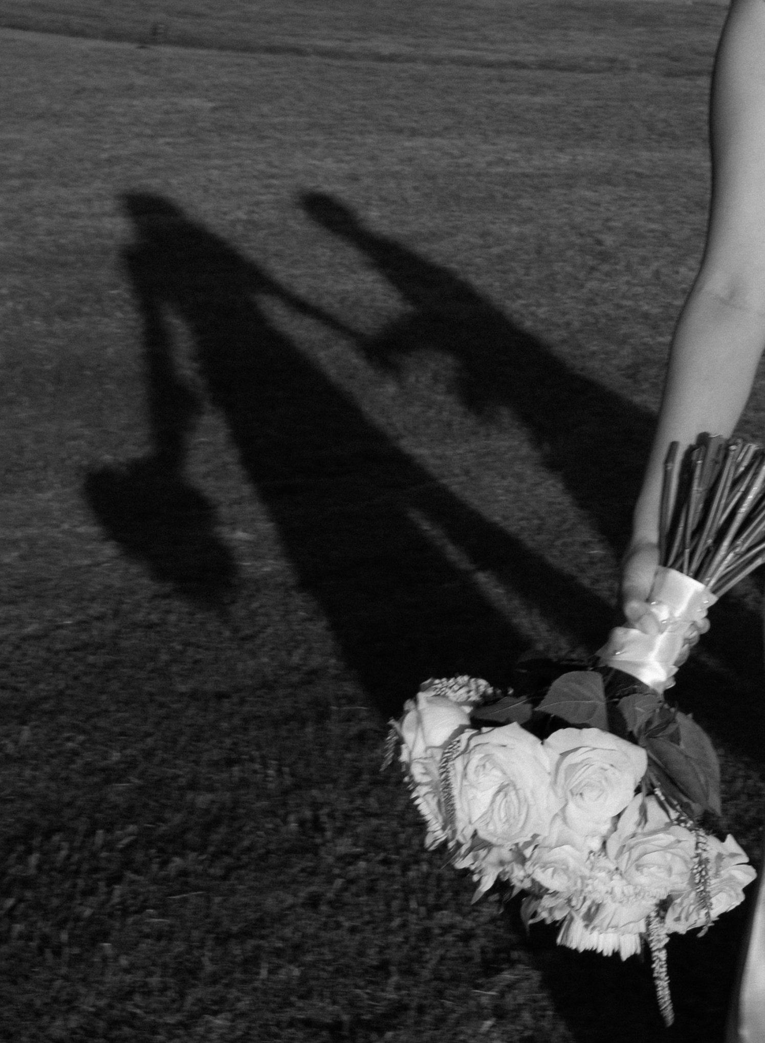 Artistic shadow detail featuring a bridal bouquet during a Fort Worth backyard wedding.
