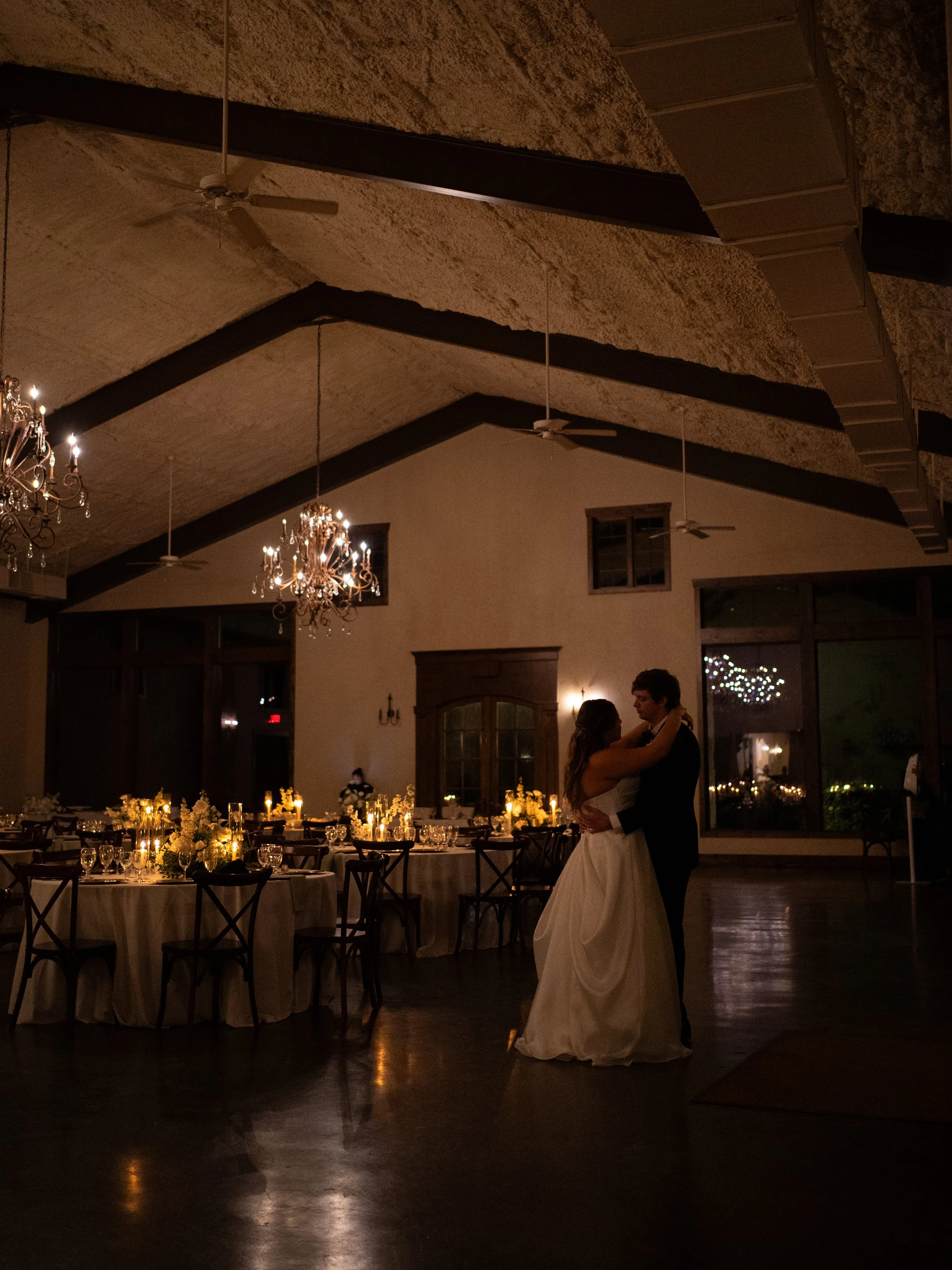 A warm and intimate first dance in Waxahachie, TX, capturing connection and quiet celebration within the reception space.