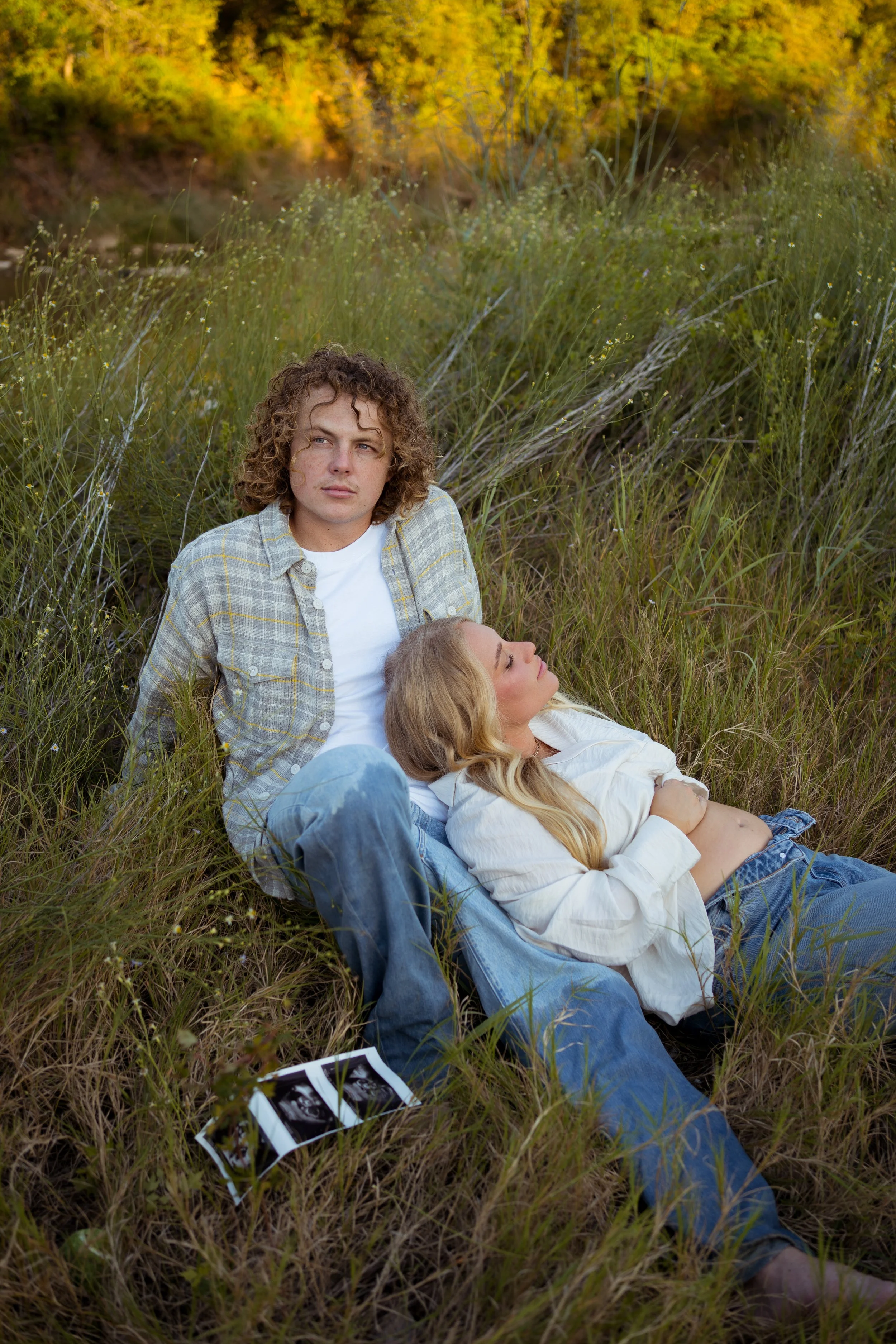 A relaxed and personal moment in Rainbow, Texas, capturing the couple with their dogs in a natural, candid setting.